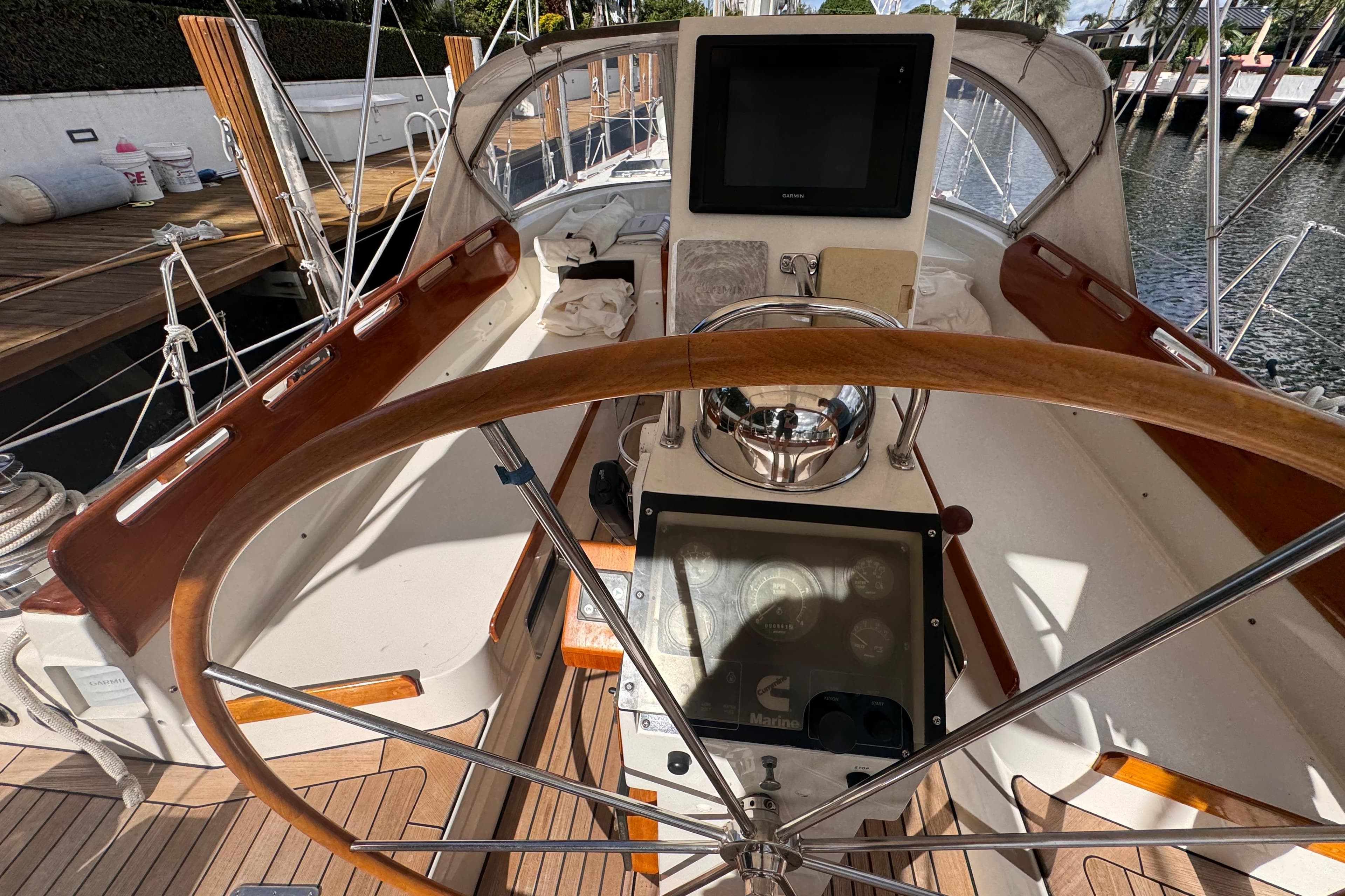 Cockpit of a 1989 Little Harbor Sloop 58' with wooden steering wheel and navigation instruments.