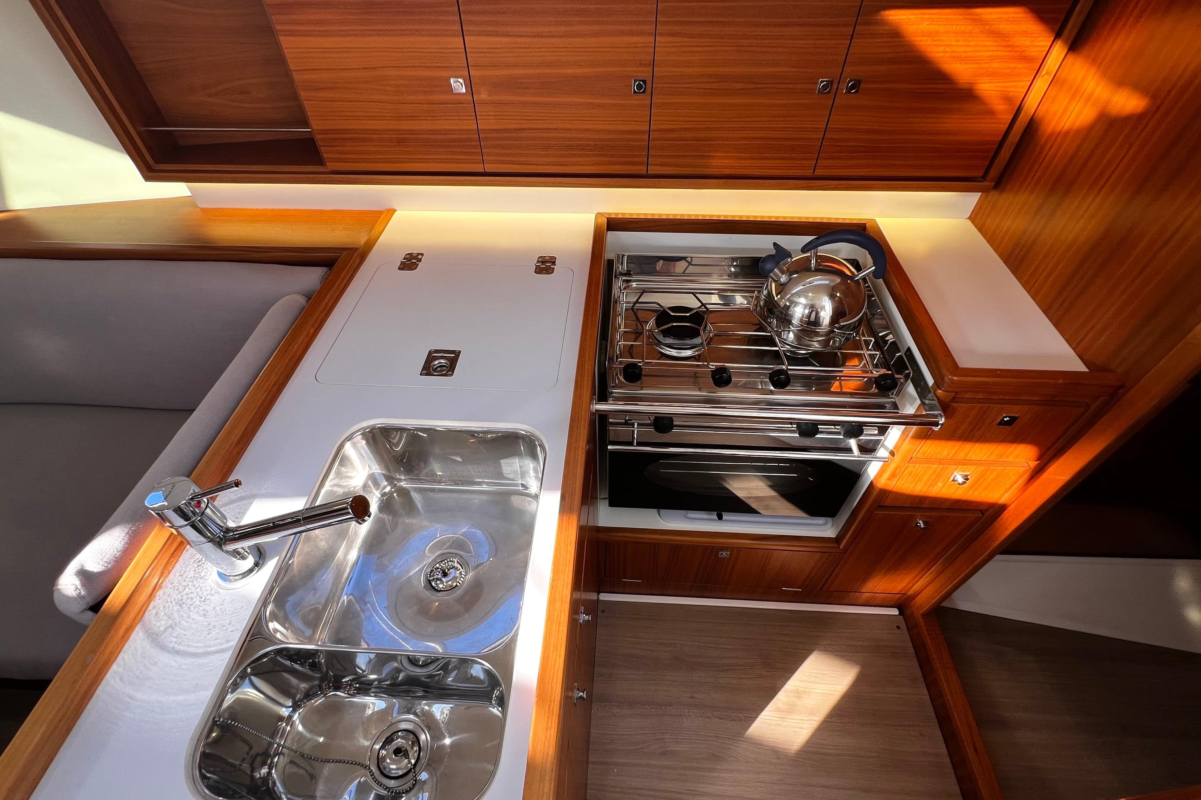 Luxurious 2018 J-Composites J/112E yacht kitchen with stainless steel sink and stove.