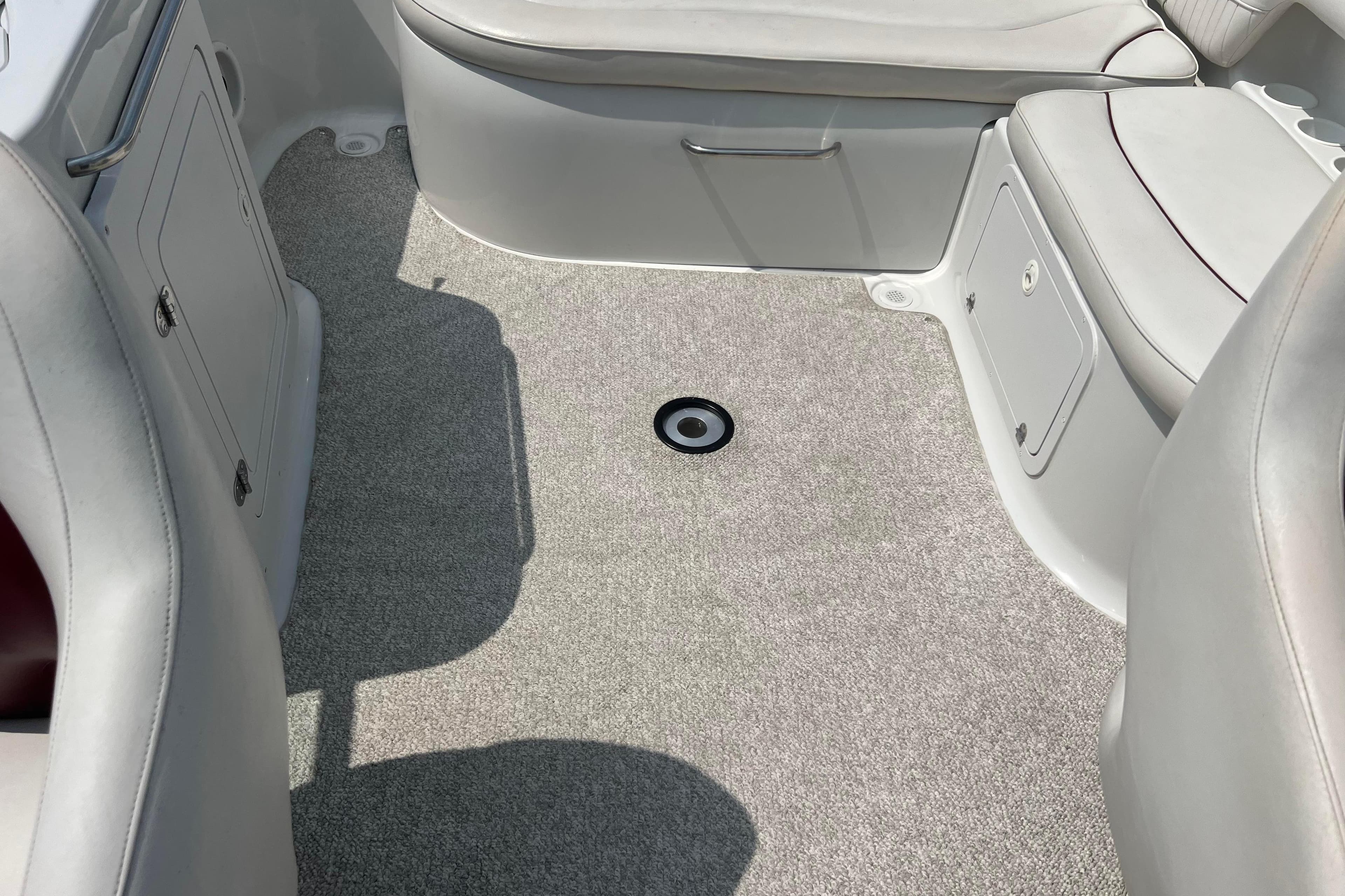 2003 Crownline 230 BR boat interior with gray carpet and white seating.