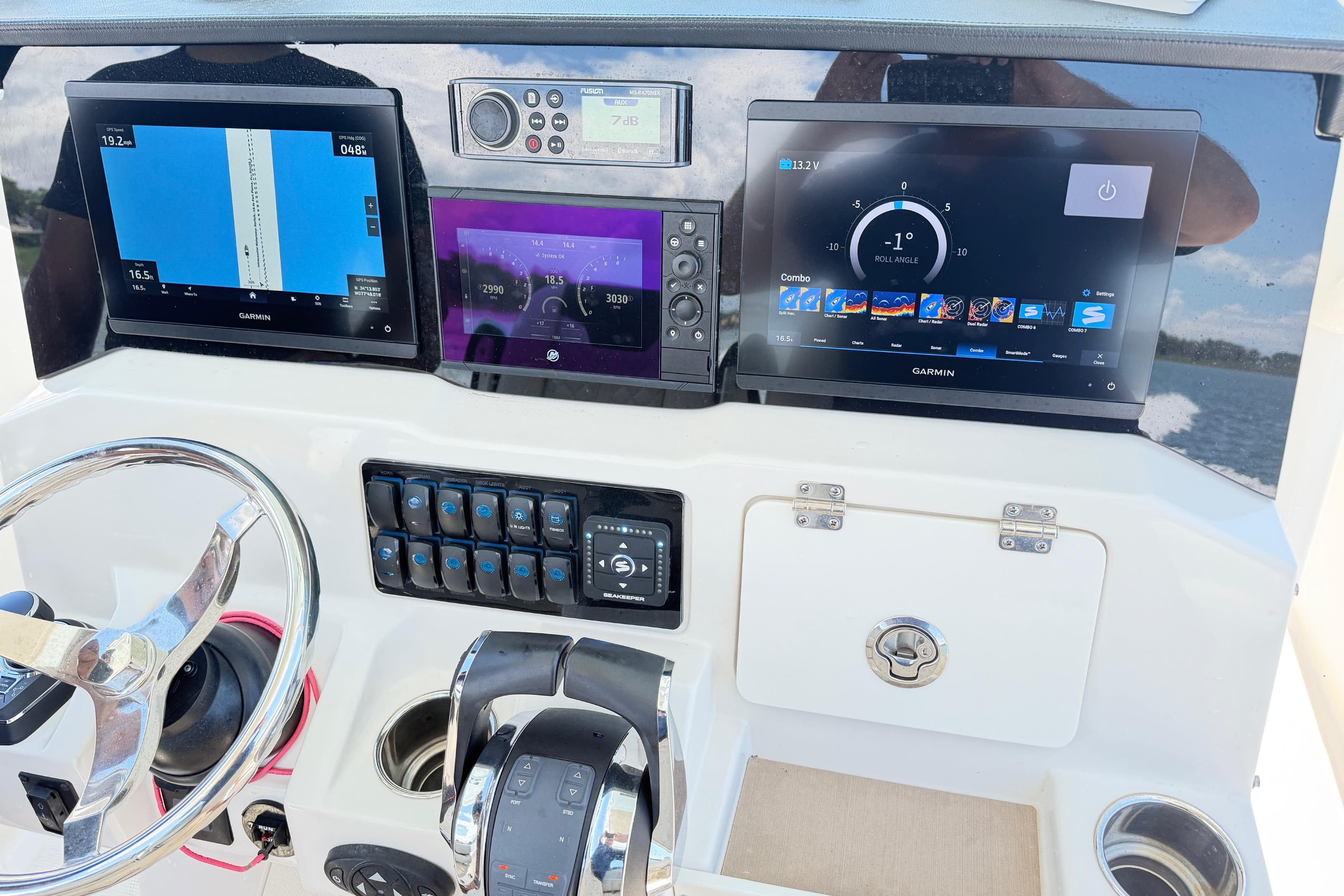 2021 Sailfish 290 CC boat dashboard with Garmin navigation displays and controls.