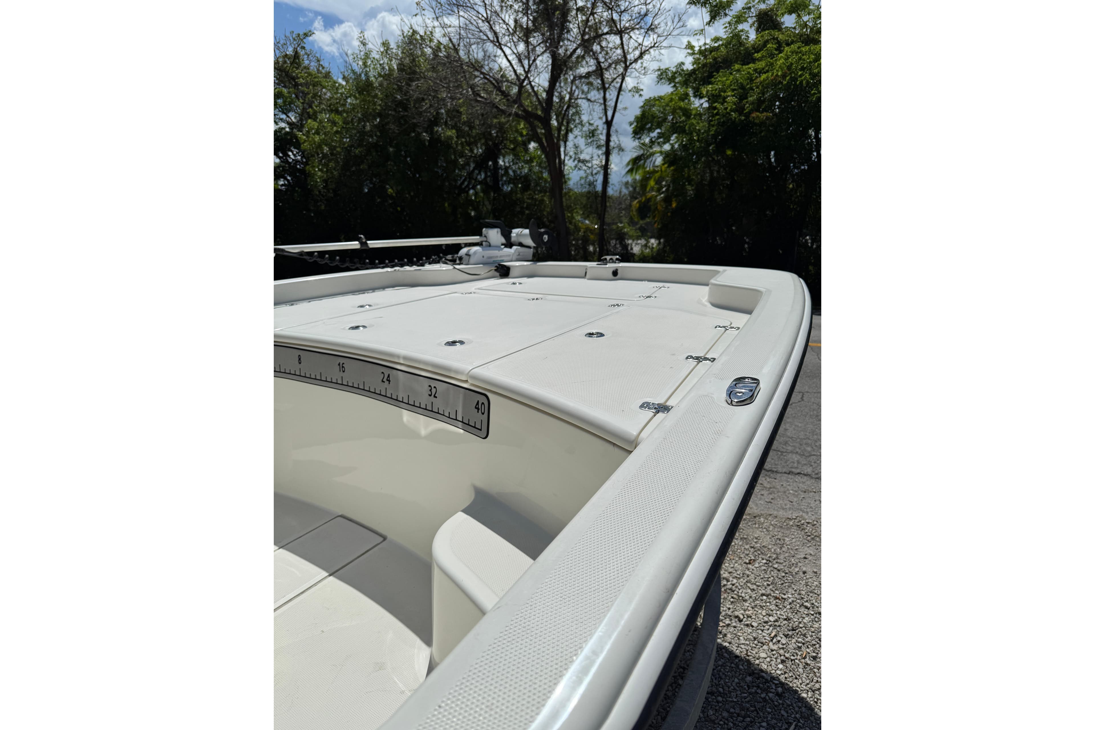 2025 Mako Pro Skiff 19 CC boat deck with storage compartments and measuring ruler.