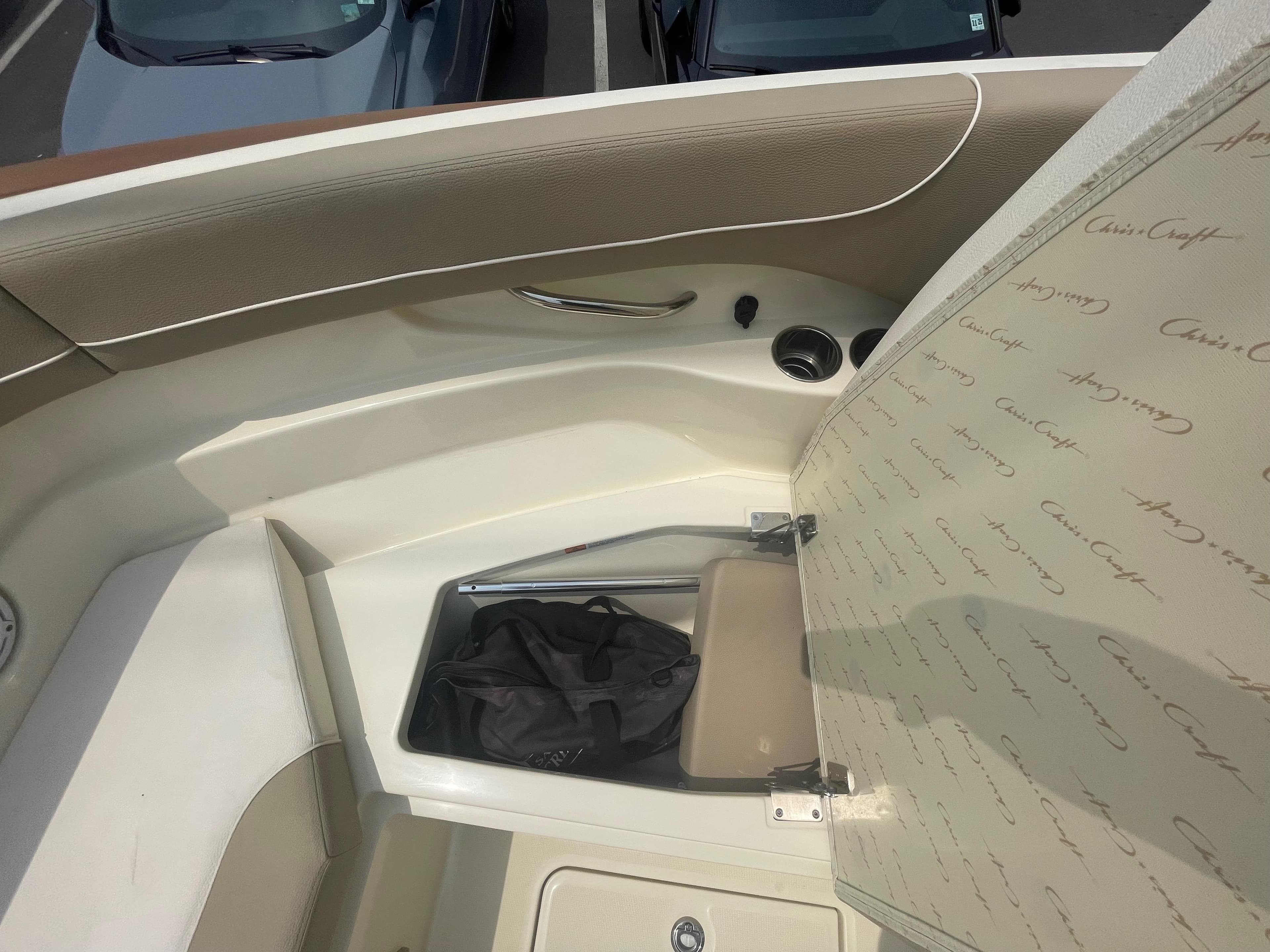 2023 Chris-Craft Calypso 28 boat interior storage compartment with open lid.