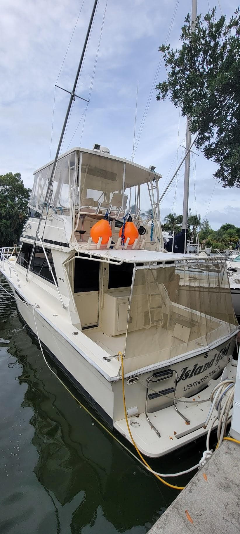 1990 Viking 35 yacht docked at marina, featuring spacious deck and flybridge.