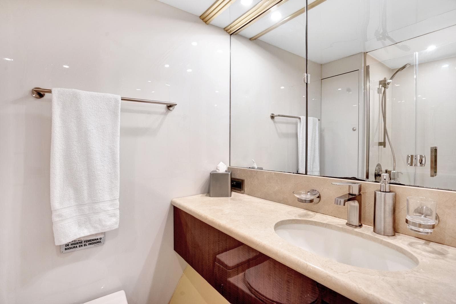 Luxurious bathroom on a 2001 Lazzara Motoryacht with elegant fixtures and marble countertop.