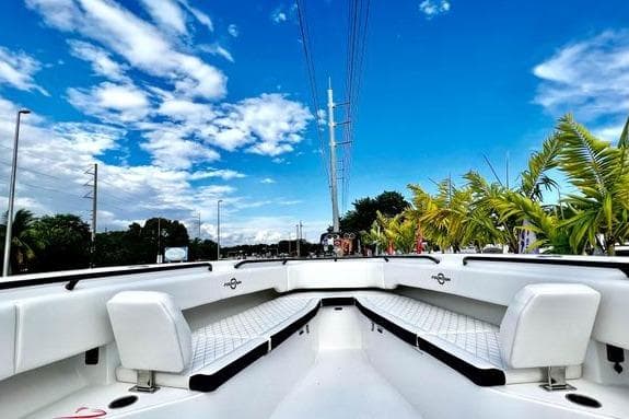 2023 Fountain 38 Tournament Edition boat with white seating, under a vibrant blue sky.