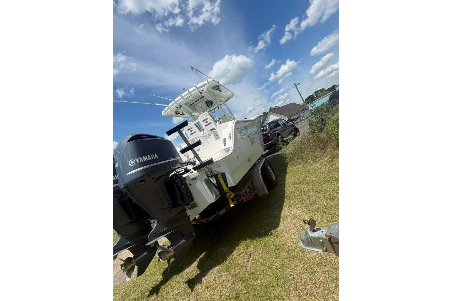 2015 Sea Fox 286 Commander boat with Yamaha engines on a trailer, under a clear blue sky.