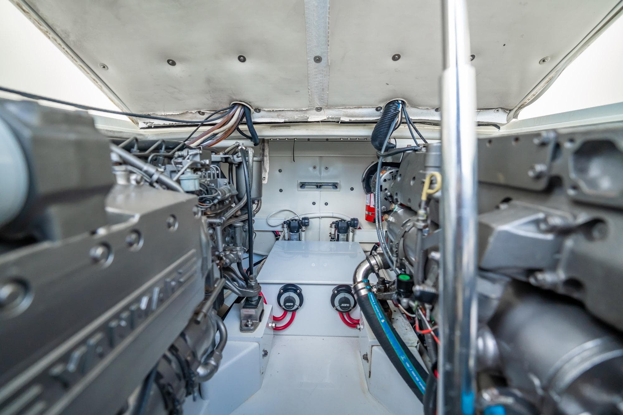 Engine room of 2003 Gamefisherman 34 Express boat, showcasing dual engines and mechanical components.