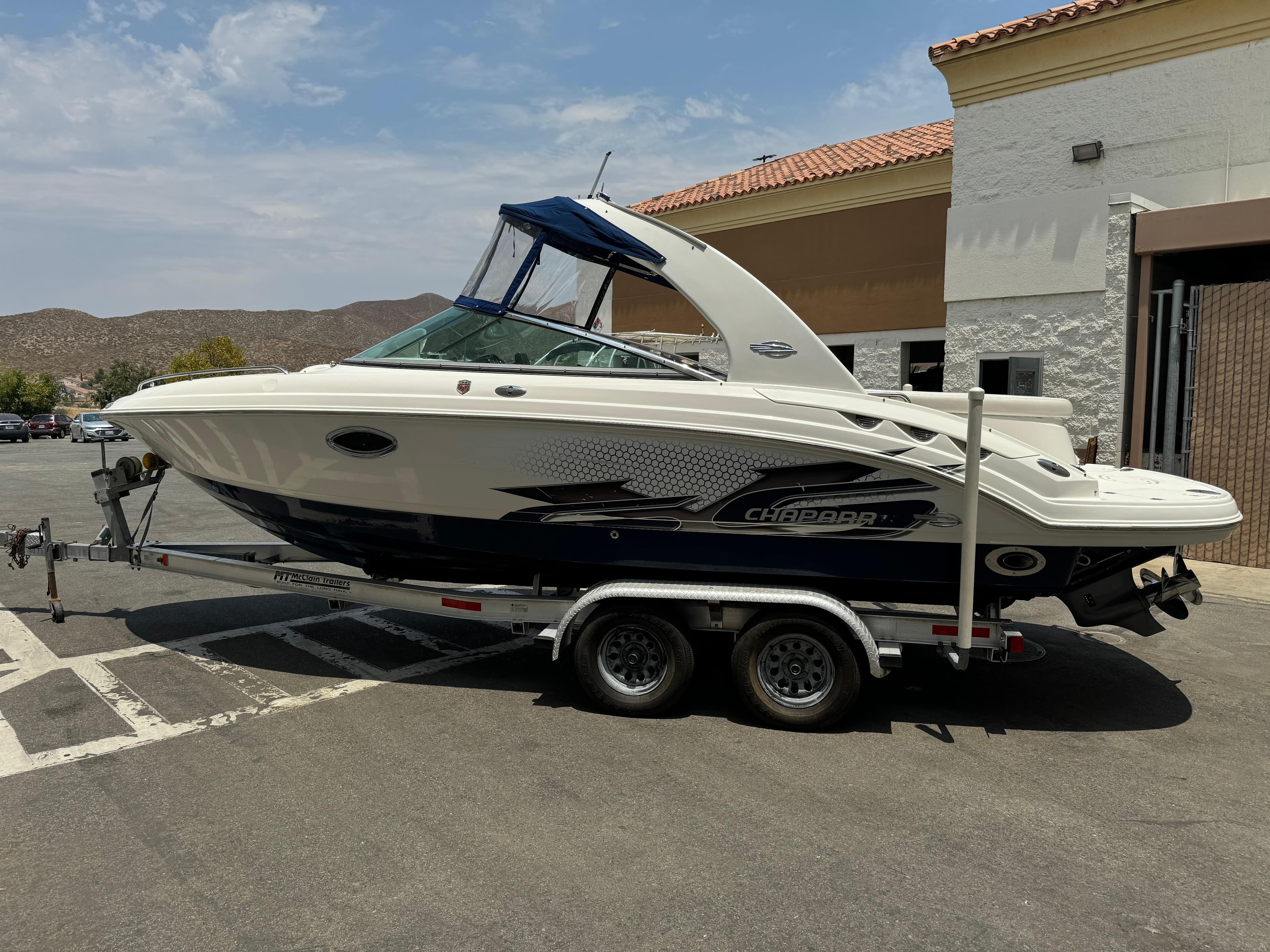 2009 Chaparral SSX 236 boat on trailer in parking lot.