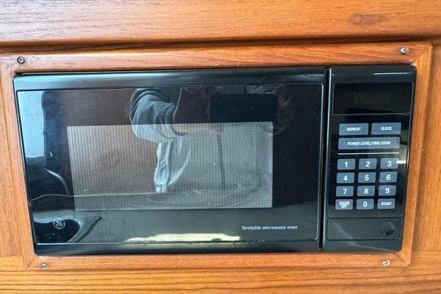 Built-in microwave in 1999 Mainship Pilot 30 Sedan boat interior.