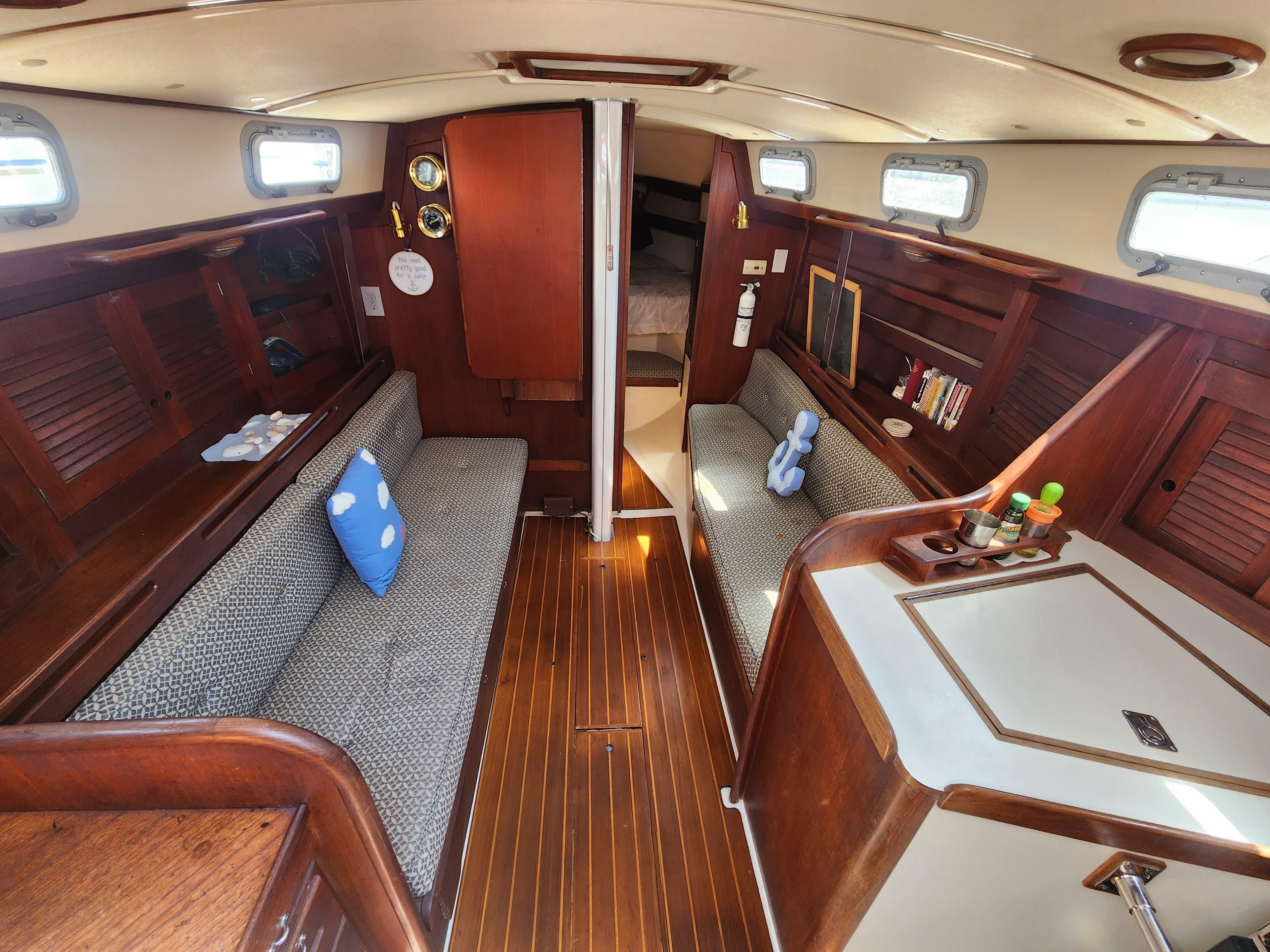 Interior of 1986 Tartan 34-2 sailboat with wood finish and cozy seating area.