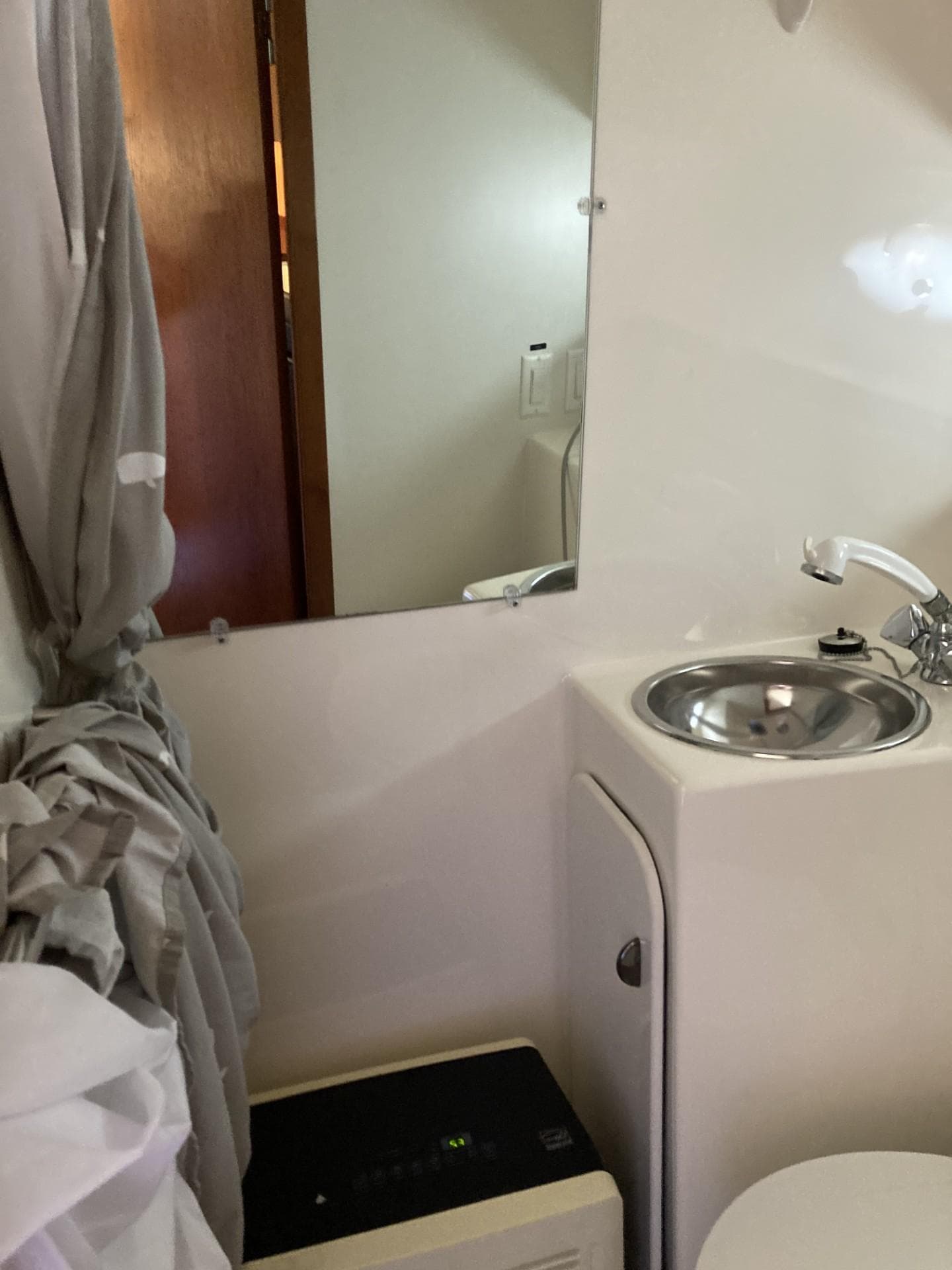 Bathroom interior of 2000 Tiara Yachts 3100 Open with sink and mirror.