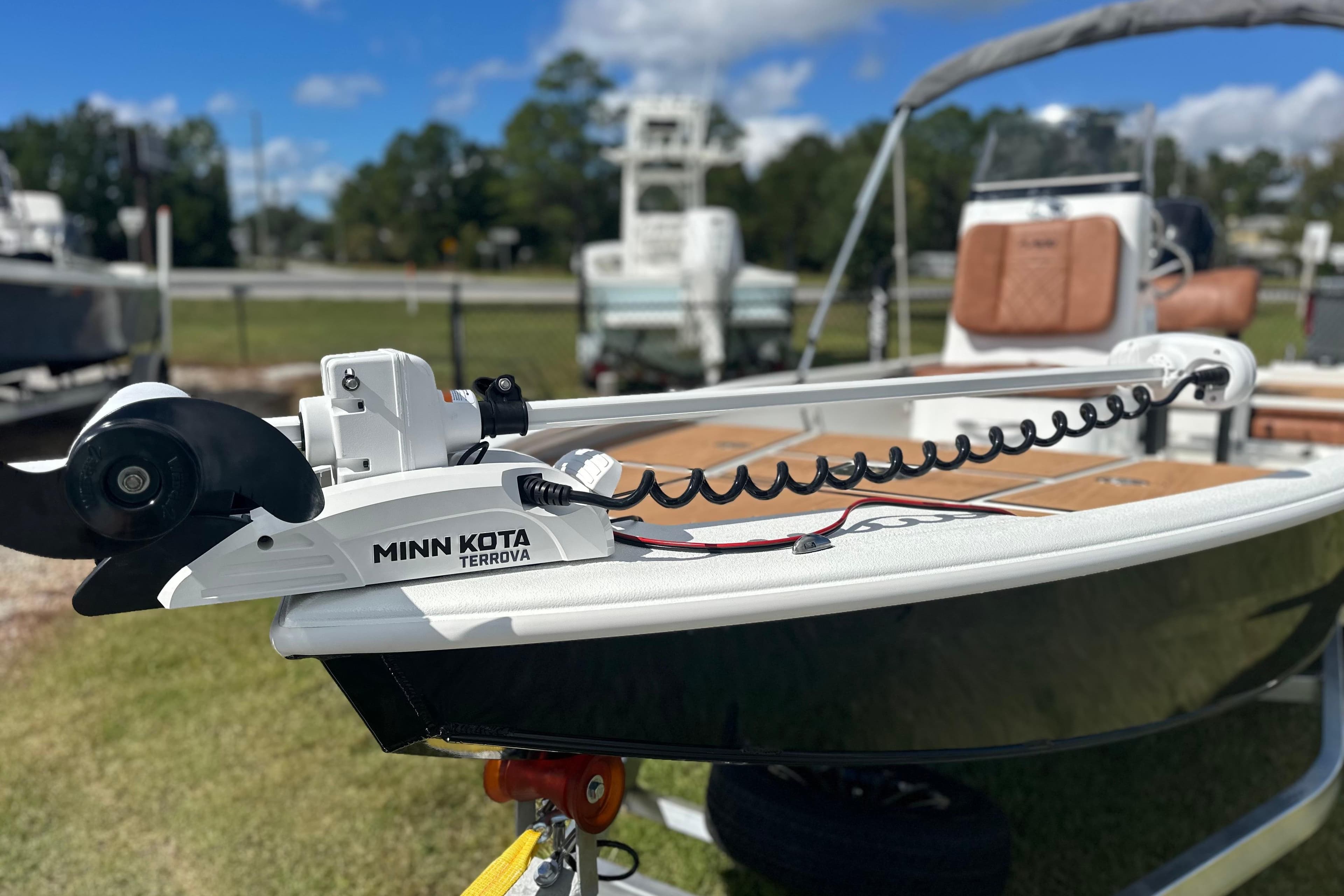 2026 Avid 19 FSX boat with Minn Kota Terrova motor, parked outdoors.