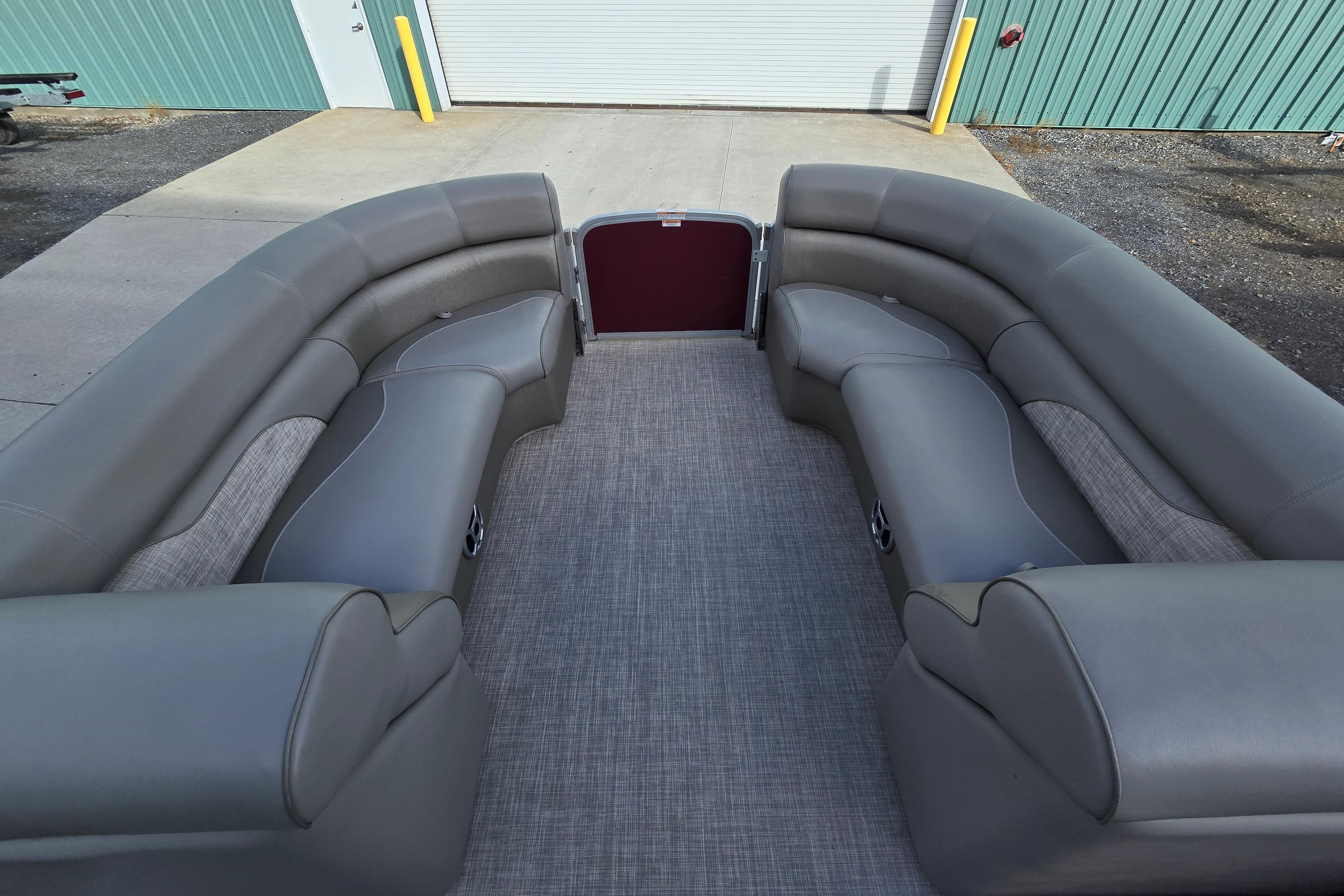 2017 Premier 220 SunSation pontoon boat with spacious gray seating and carpeted deck.
