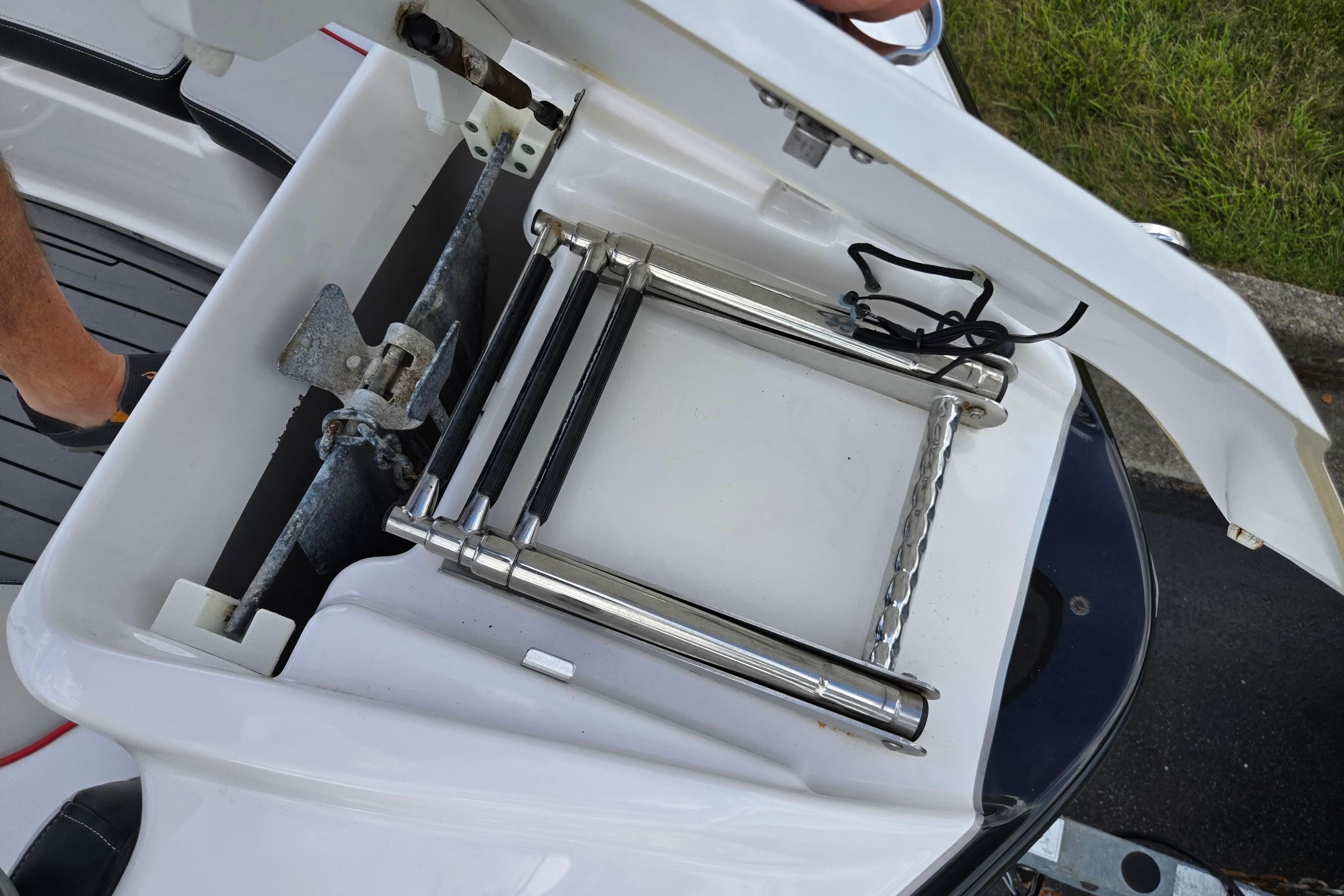 2018 Yamaha Boats 212X anchor and ladder storage compartment open.
