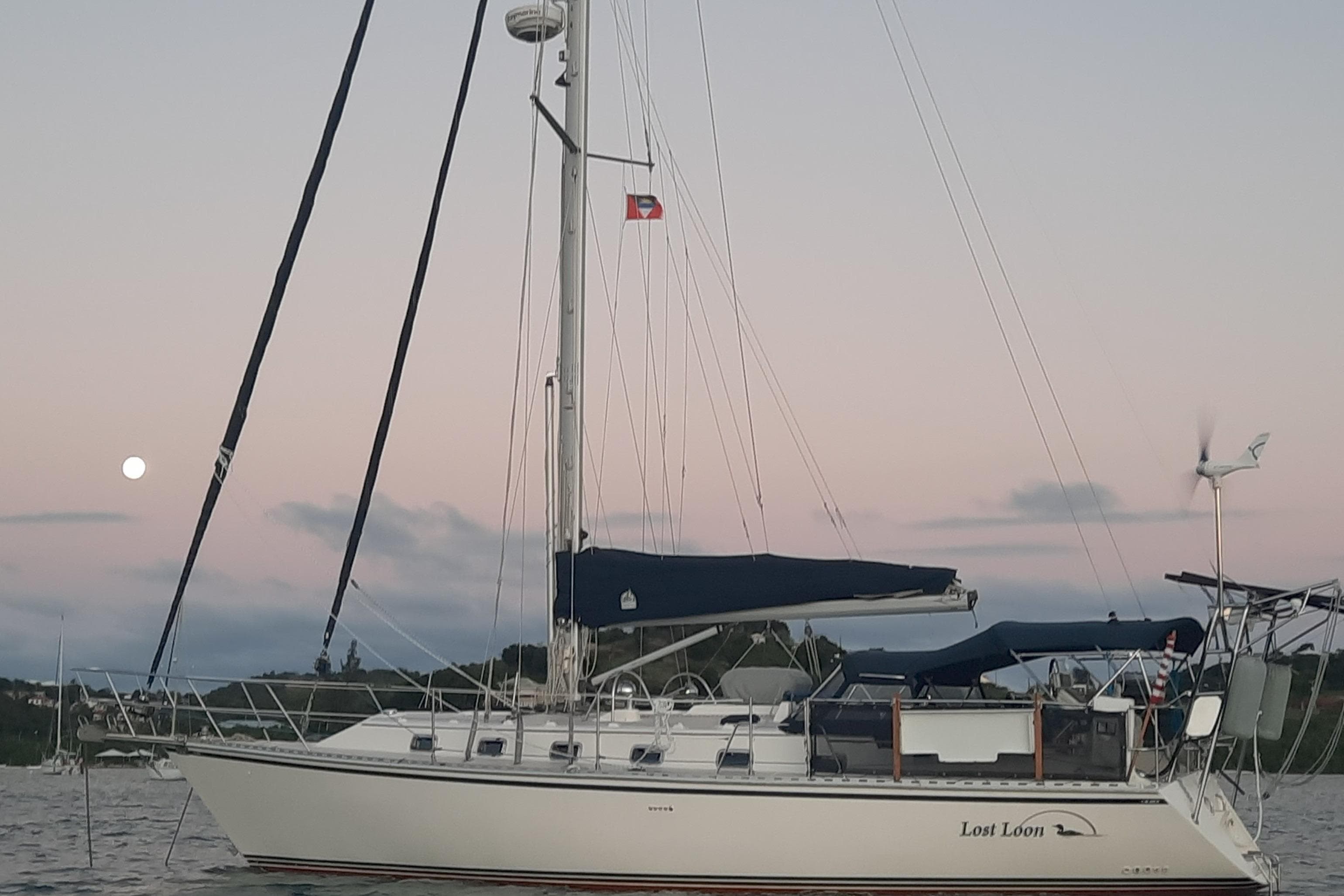 Sailboat "Lost Loon," Caliber 40LRC SE 2005, anchored at sunset with moon in background.