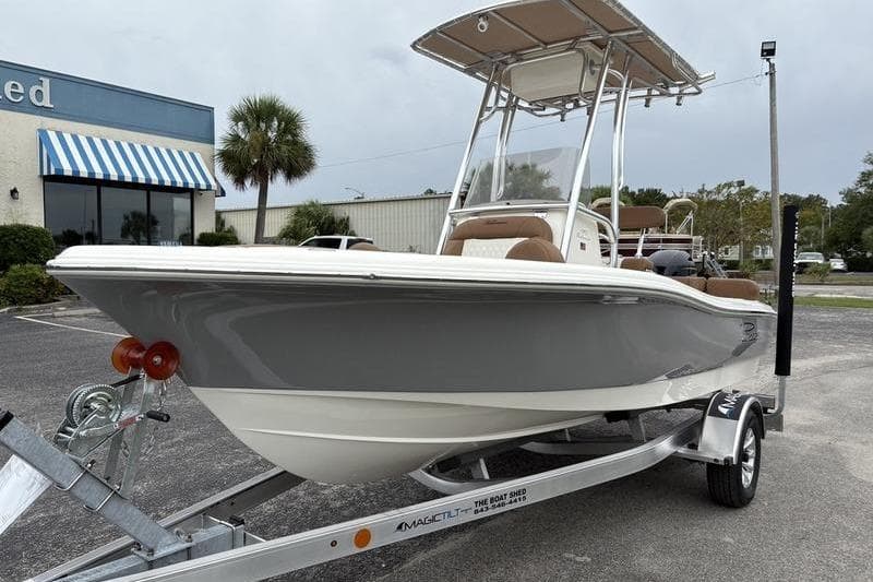 2026 Pioneer Islander 180 boat on trailer, parked outside a building.