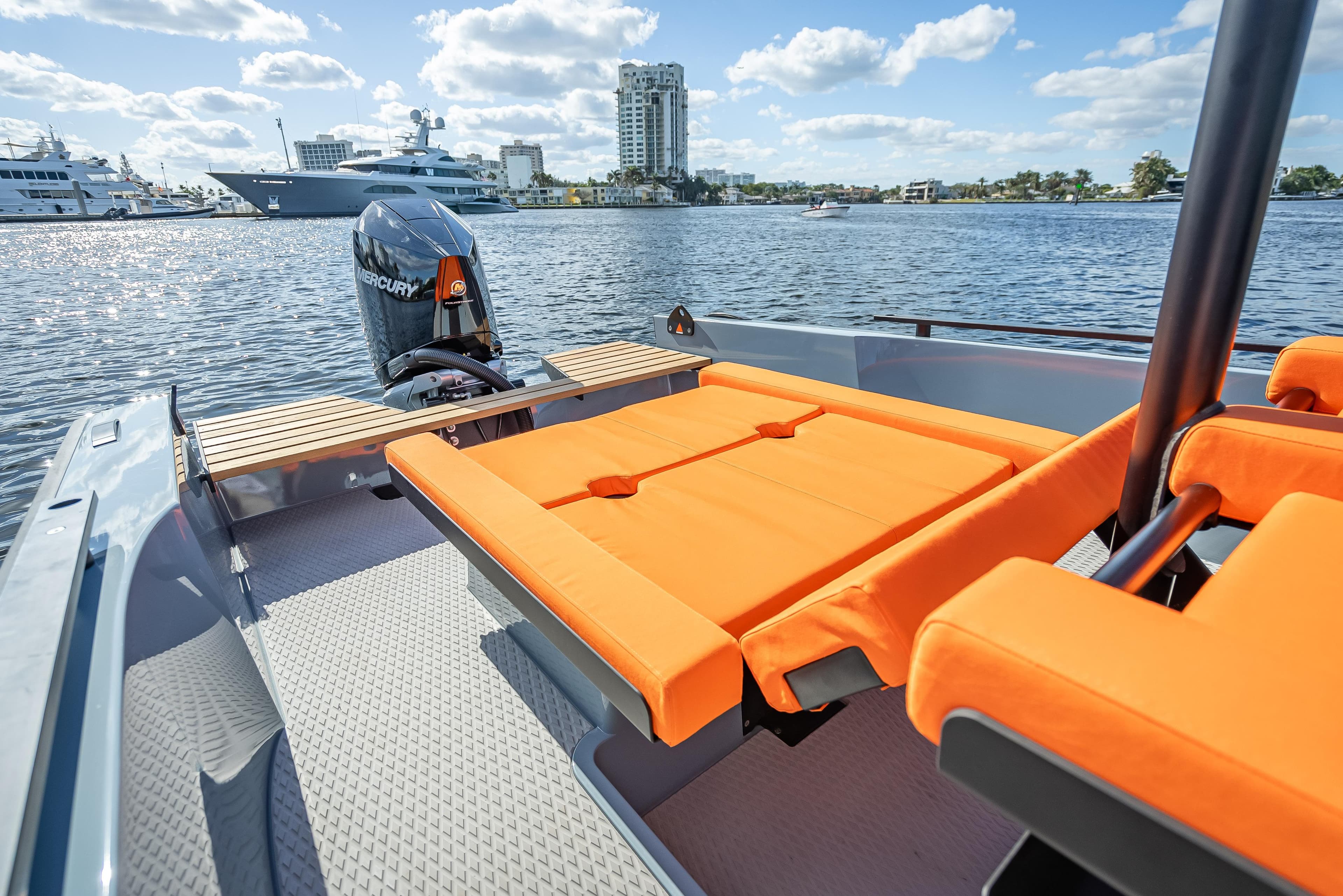 2024 Goldfish 28 Tender boat with orange seating on a sunny day.
