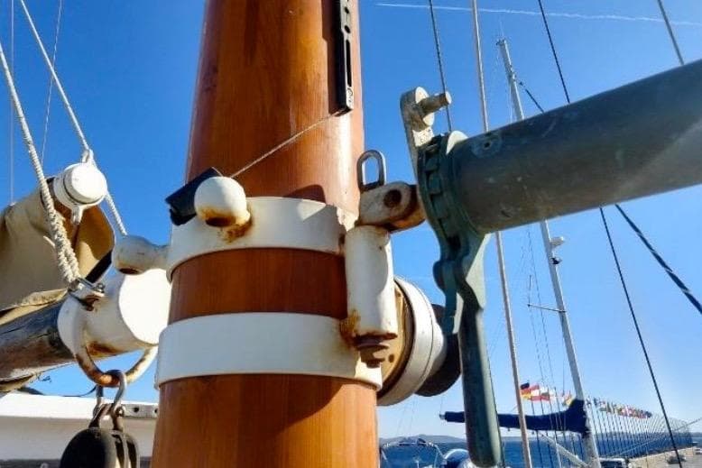 Close-up of a 1940 Brigantin Passagers Tourisme sailboat mast with rigging details.