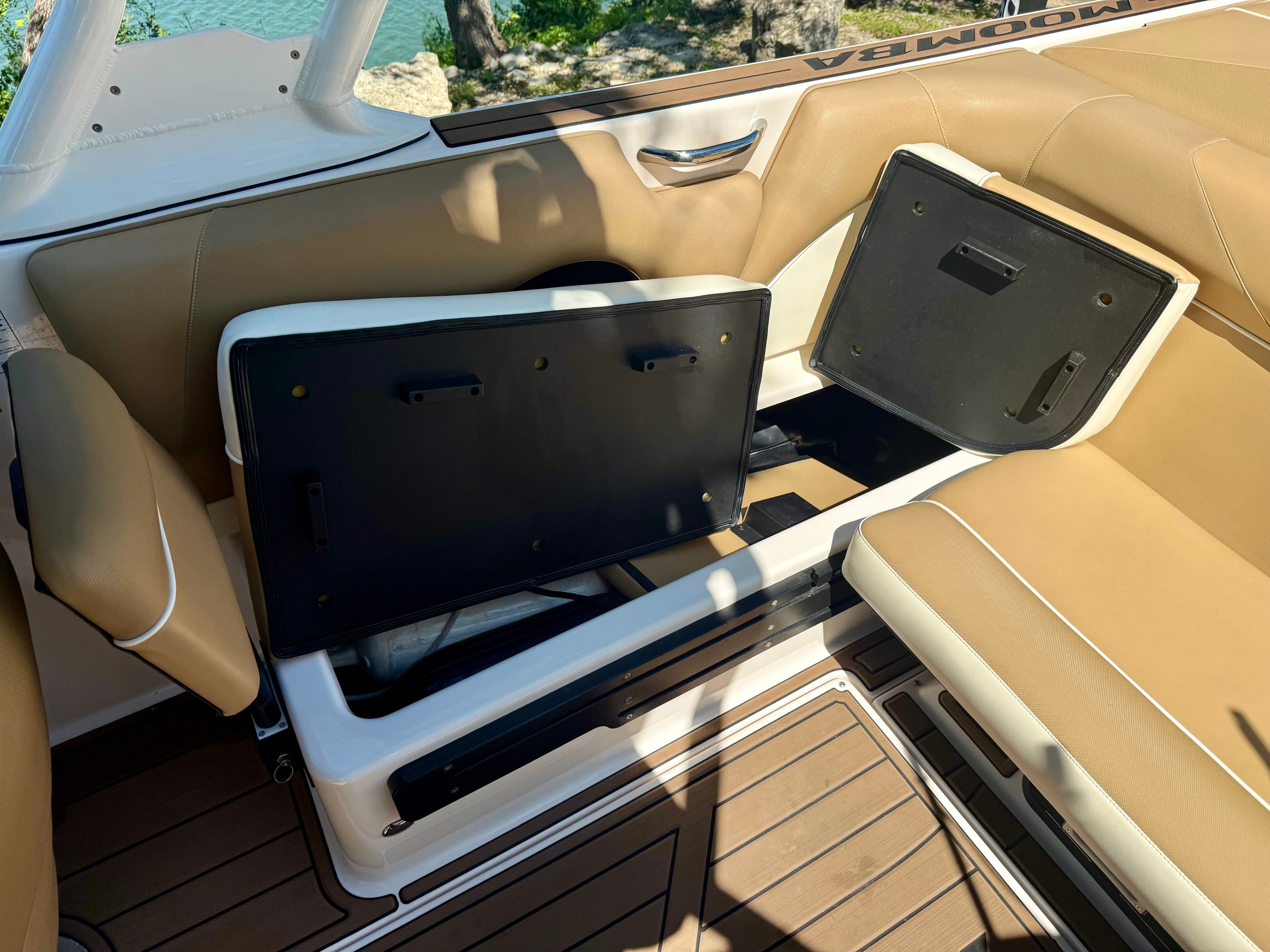 2019 Moomba Craz boat with open storage compartments and beige seating.