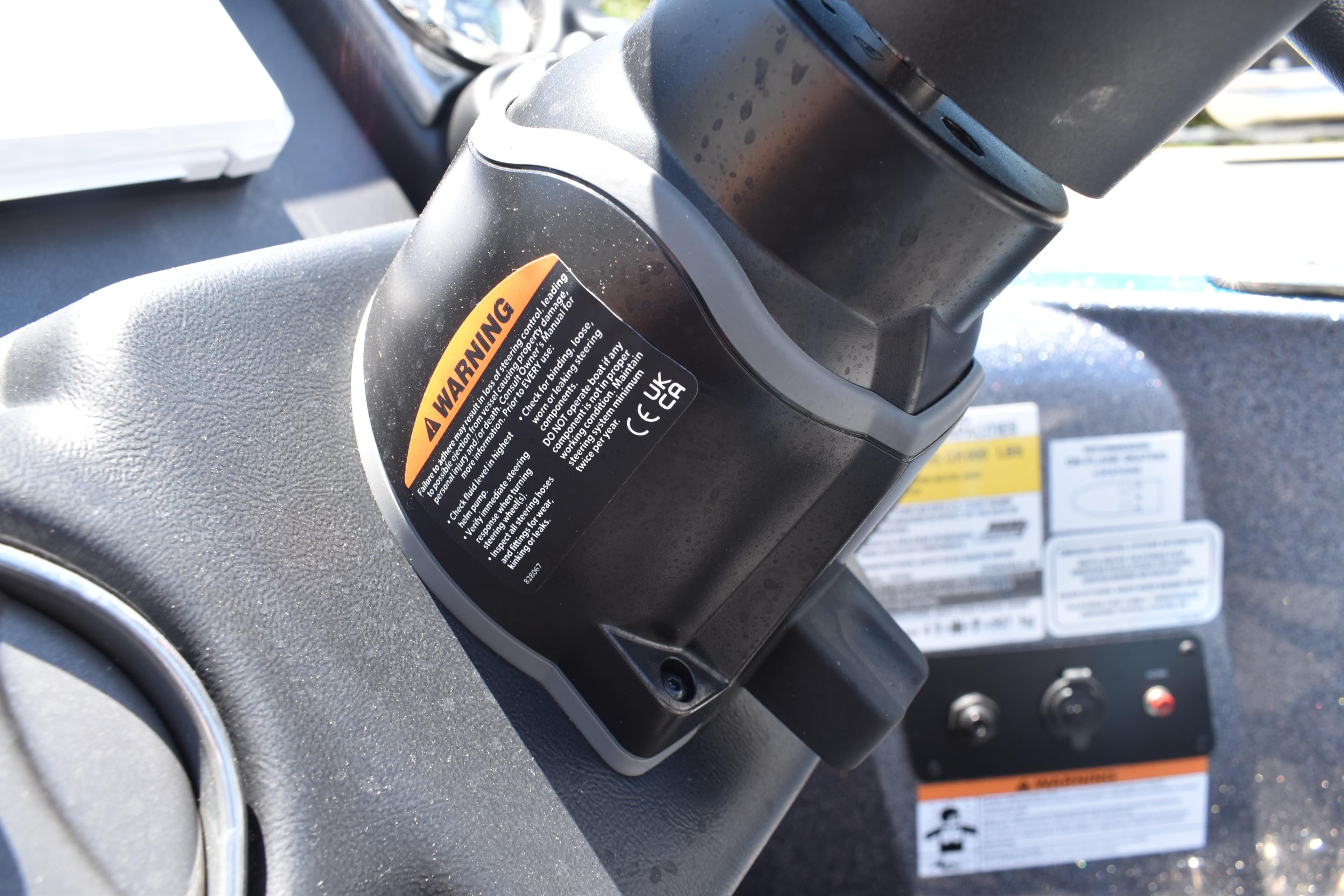 Close-up of a 2026 Triton 179 TrX boat dashboard with warning labels.