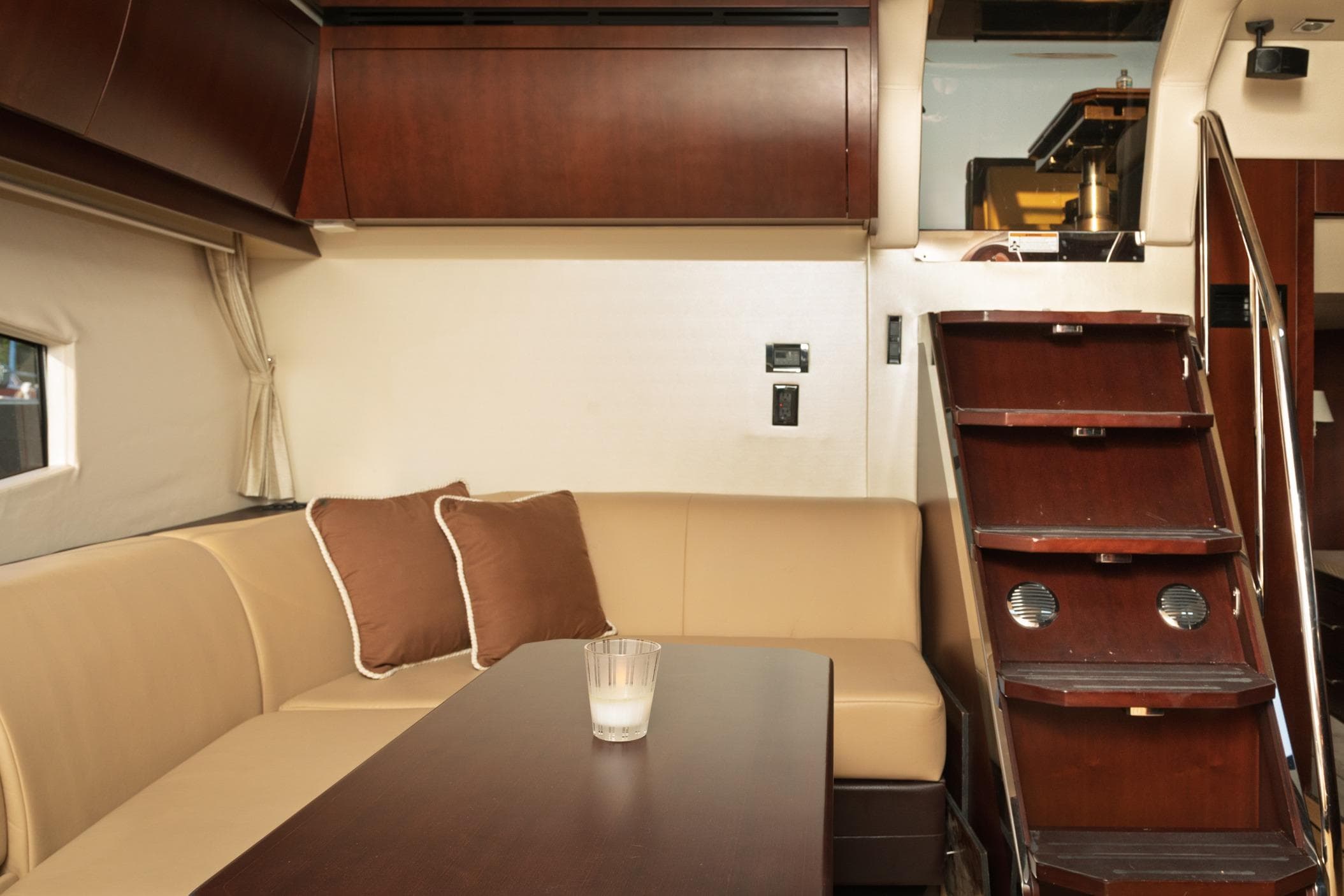Luxurious interior of 2015 Regal 53 Sport Coupe with elegant seating and wooden stairs.