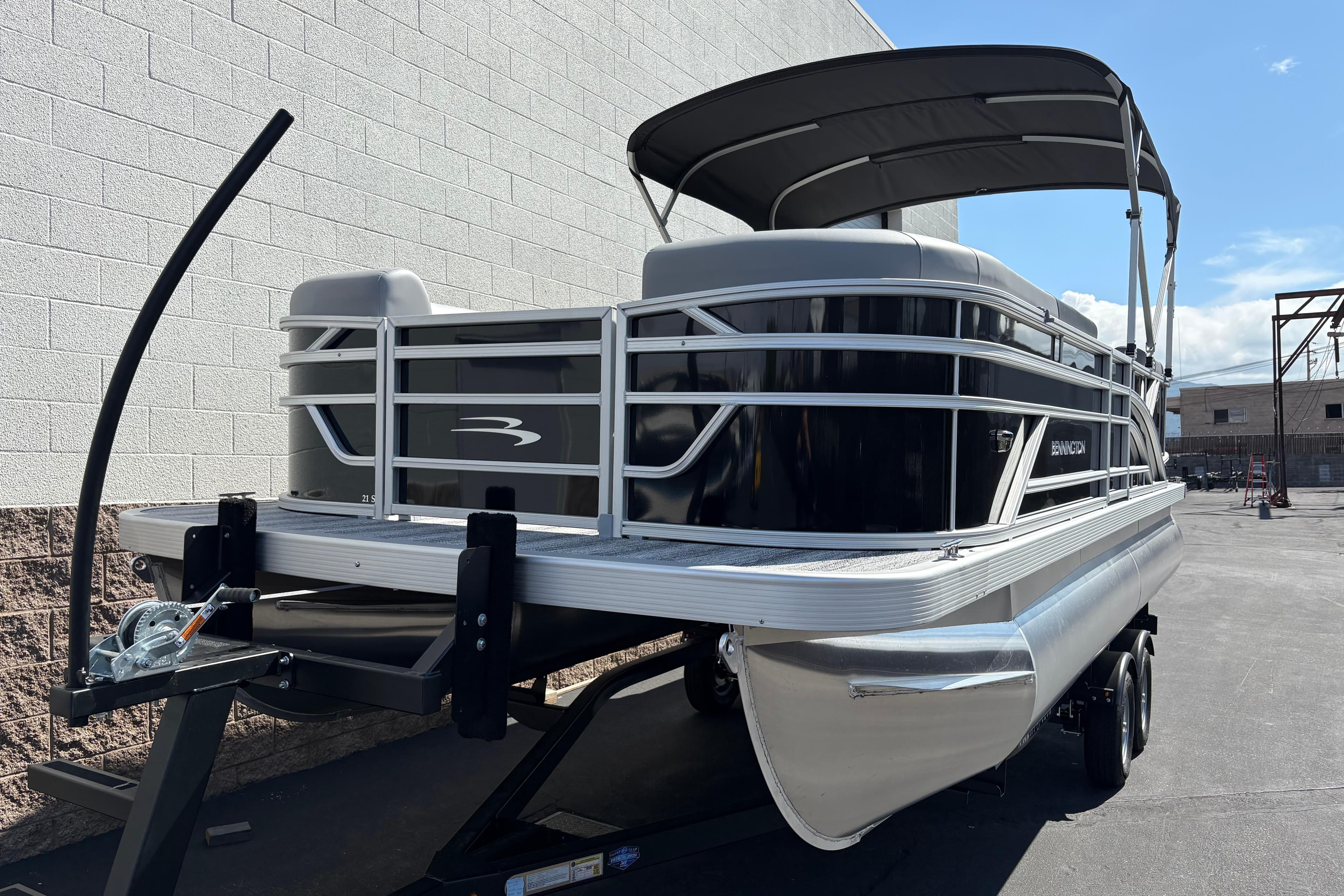 2026 Bennington 21 SSR pontoon boat on trailer, parked outdoors.
