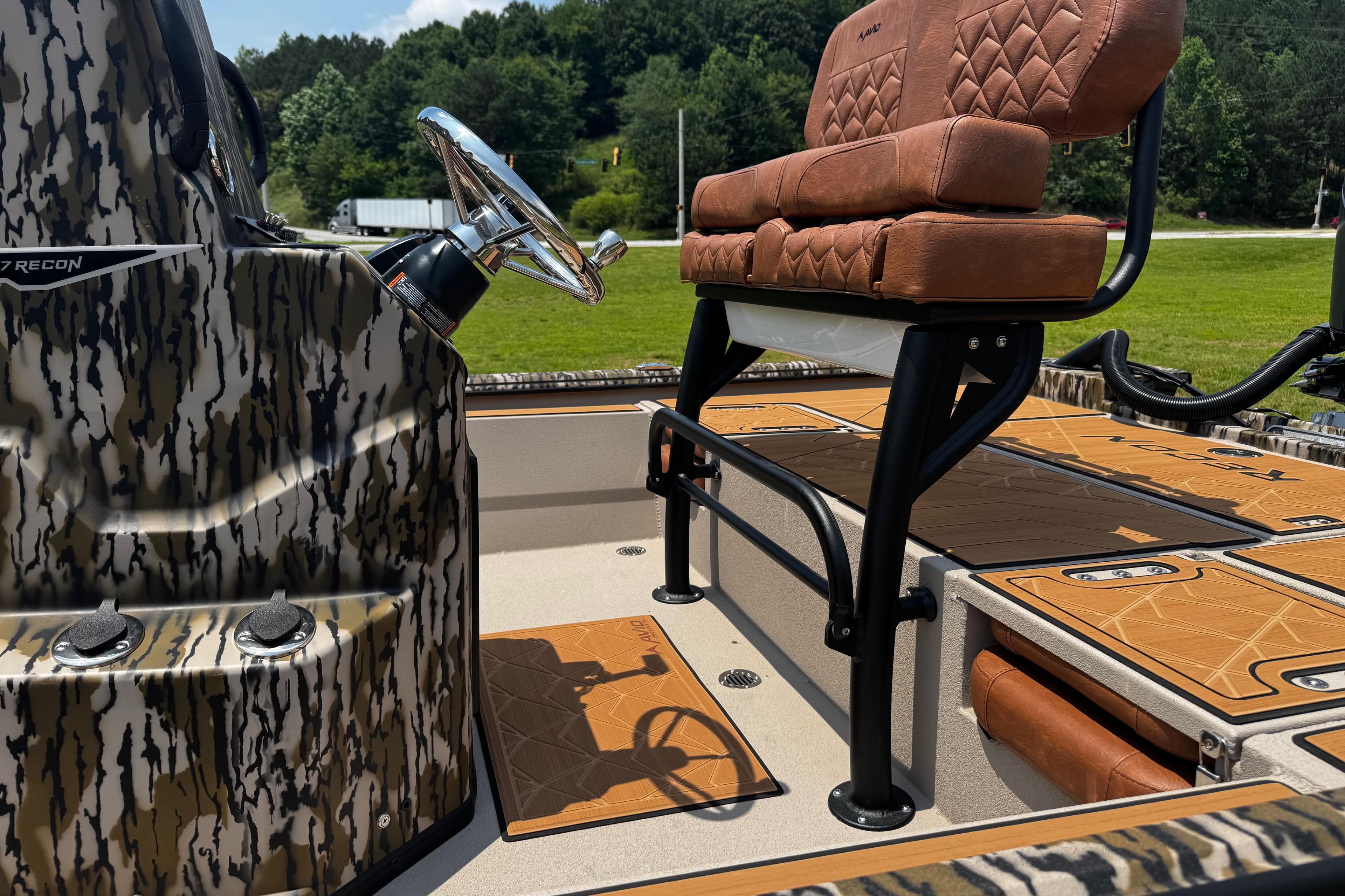 2026 Avid 207 Recon boat interior with camo design and brown seating.