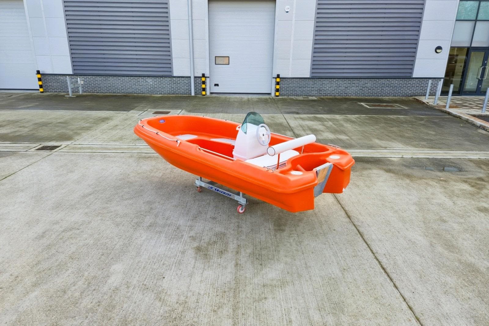 Orange Rigiflex New Matic 400 Console Version boat, 2025 model, on concrete surface.