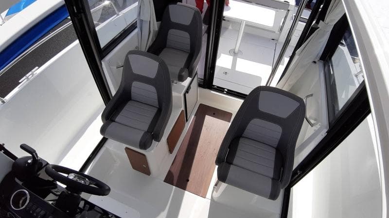 Interior of 2025 Jeanneau 795 SPORT S2 boat with three modern seats.