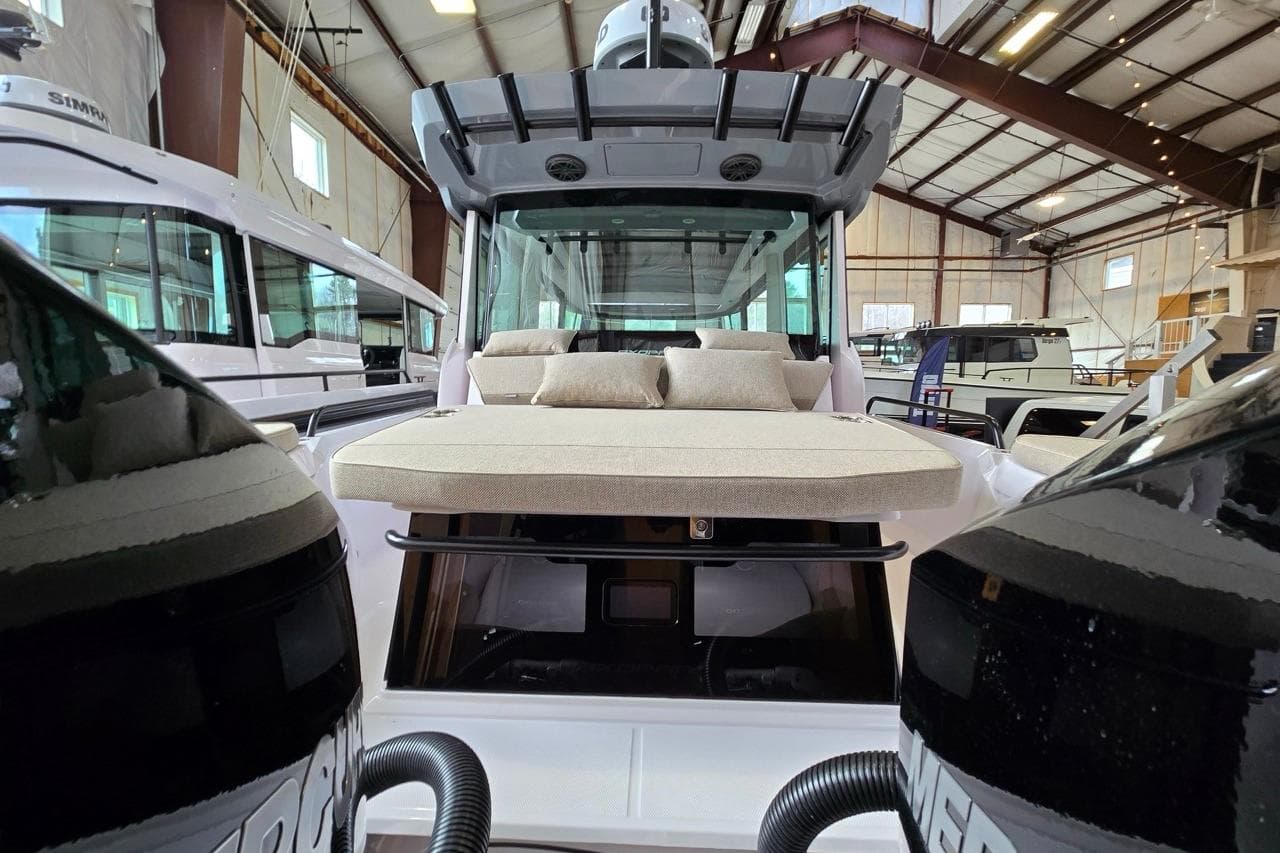 2026 Axopar 29 XC Cross Cabin boat in a showroom, featuring a spacious deck and modern design.