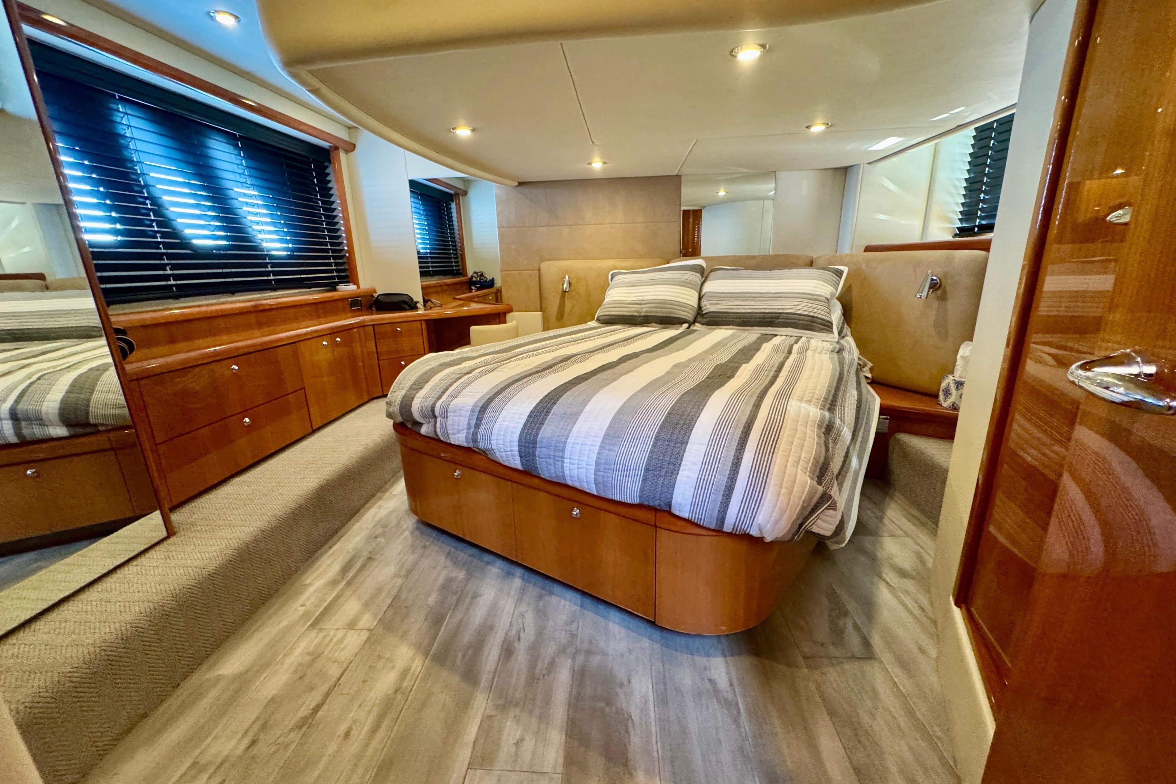Luxurious bedroom interior of 2005 Sunseeker Manhattan 50 yacht with modern decor.