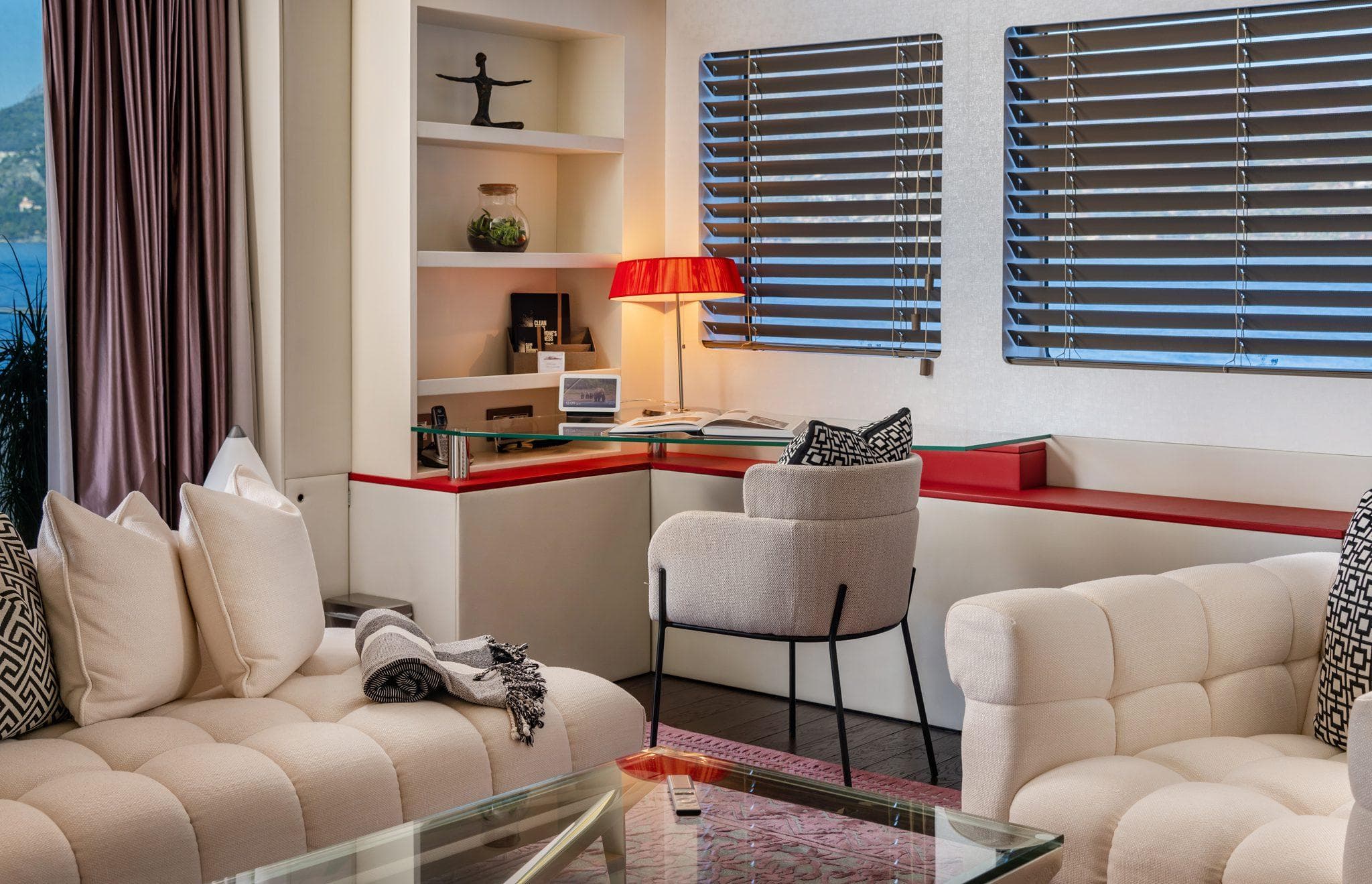 Luxurious yacht interior with modern decor, plush seating, and scenic ocean view.