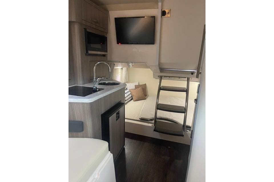 Interior of 2020 Regal 28 Express boat with kitchenette and sleeping area.