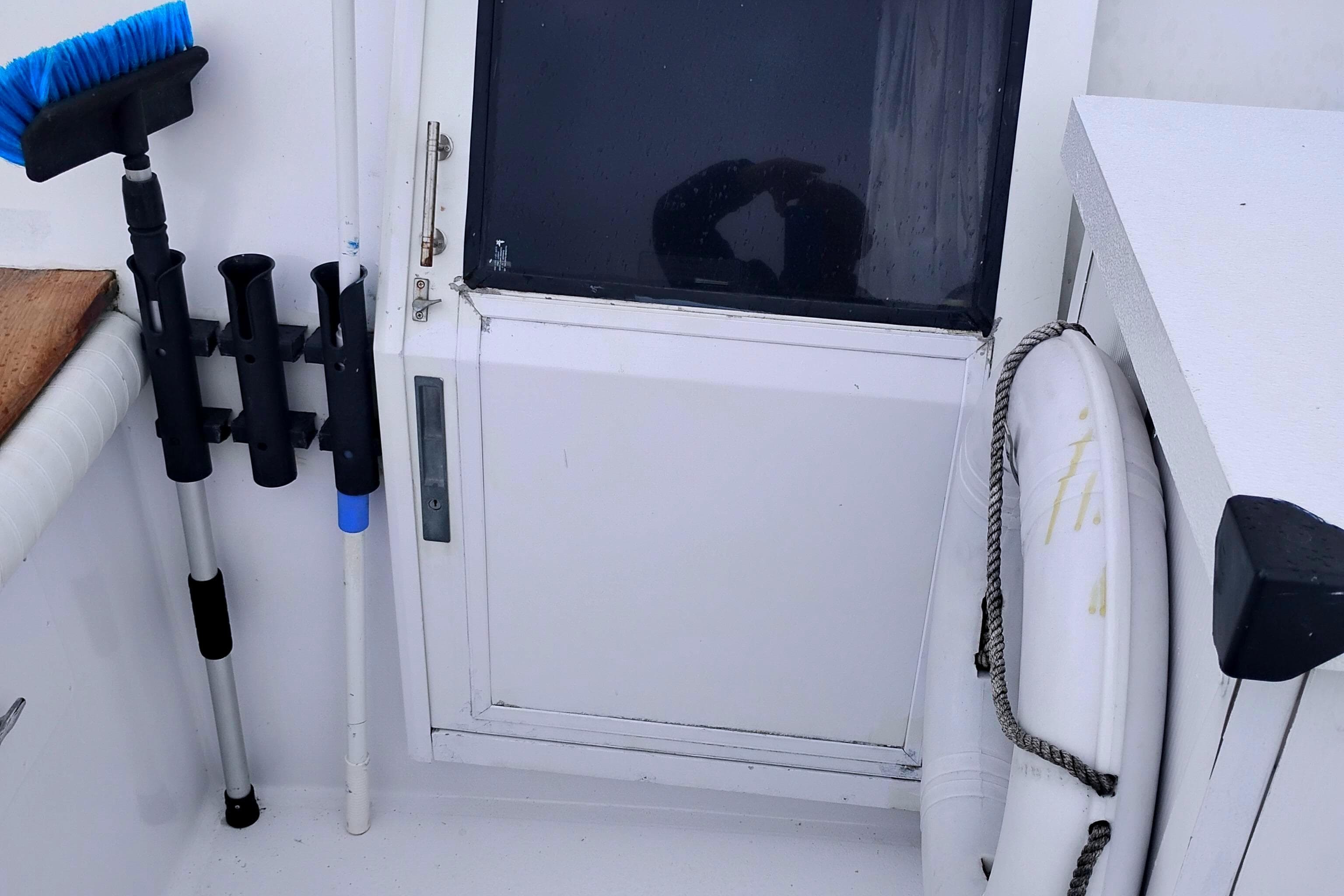 1991 Californian 52 Cockpit Motor Yacht deck with cleaning tools and life preserver.