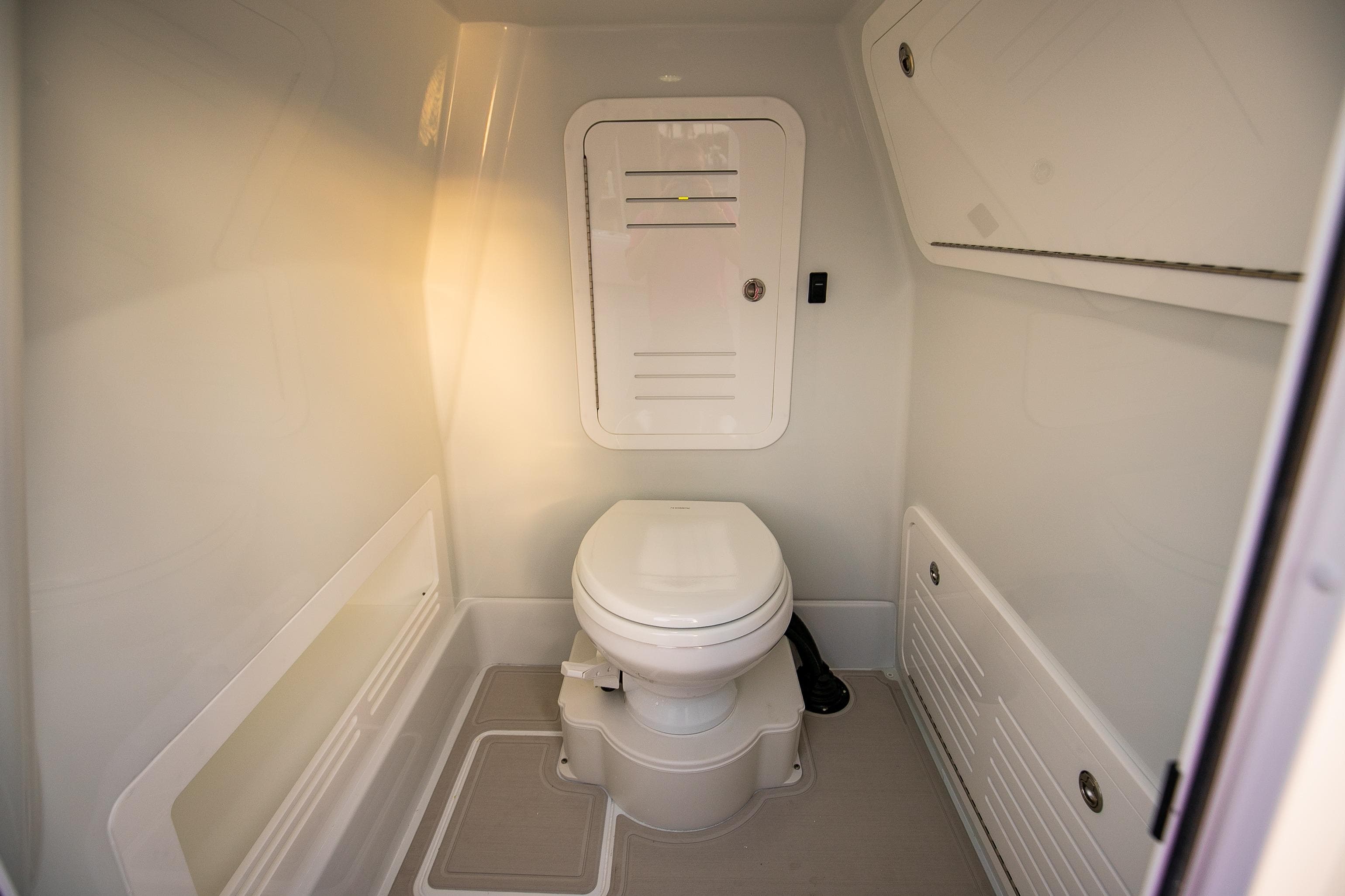2026 Yellowfin 36 Offshore boat interior bathroom with modern design and compact toilet.
