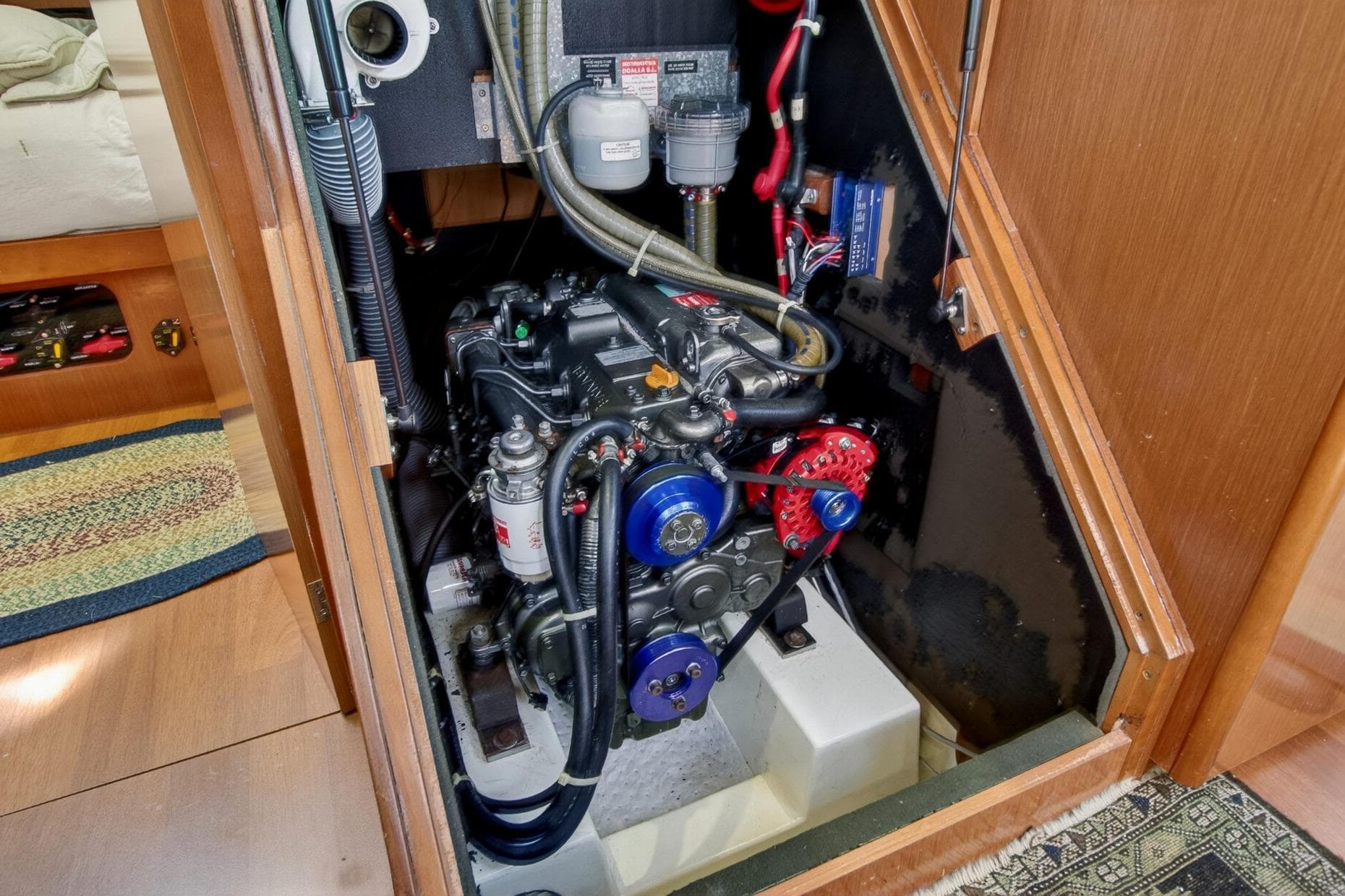 Engine compartment of a 2012 Beneteau Oceanis 48 sailboat, showcasing mechanical components.