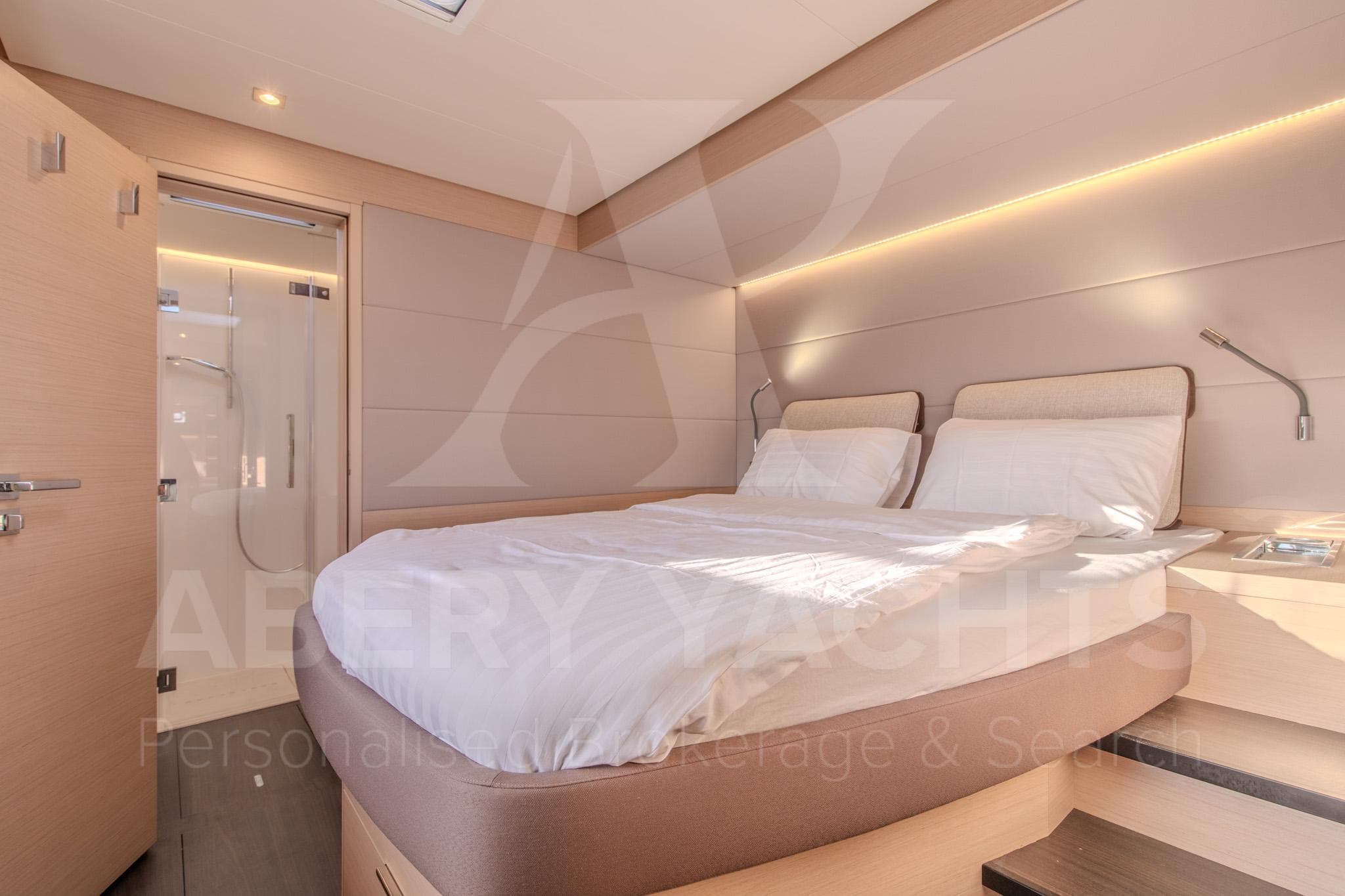 Luxurious bedroom interior of 2024 Lagoon 55 yacht with modern design and ensuite bathroom.