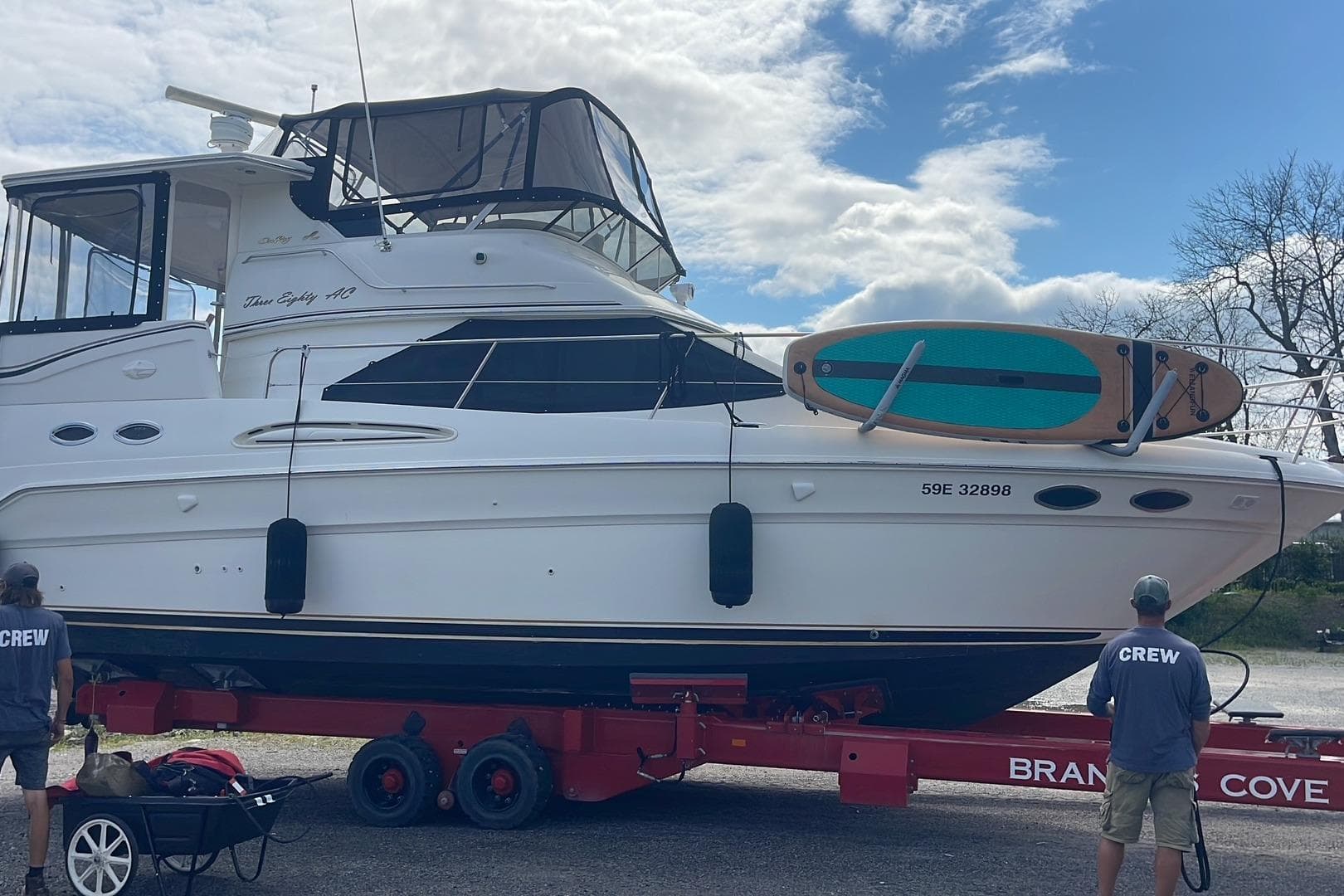 2000 Sea Ray 380 Aft Cabin yacht on trailer with crew members nearby.
