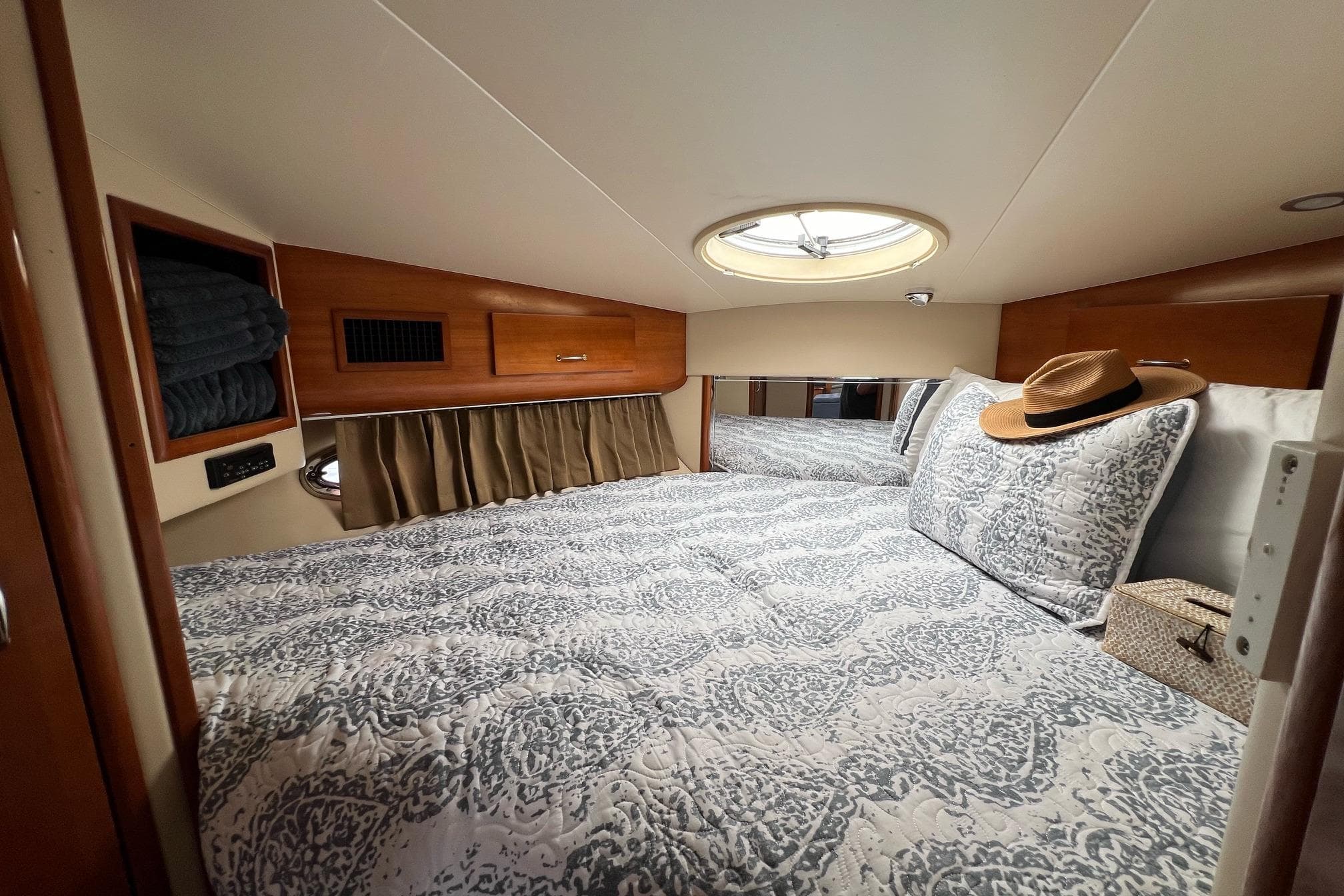 Luxurious 2003 Carver 444 Cockpit Motor Yacht bedroom with elegant bedding and natural light.