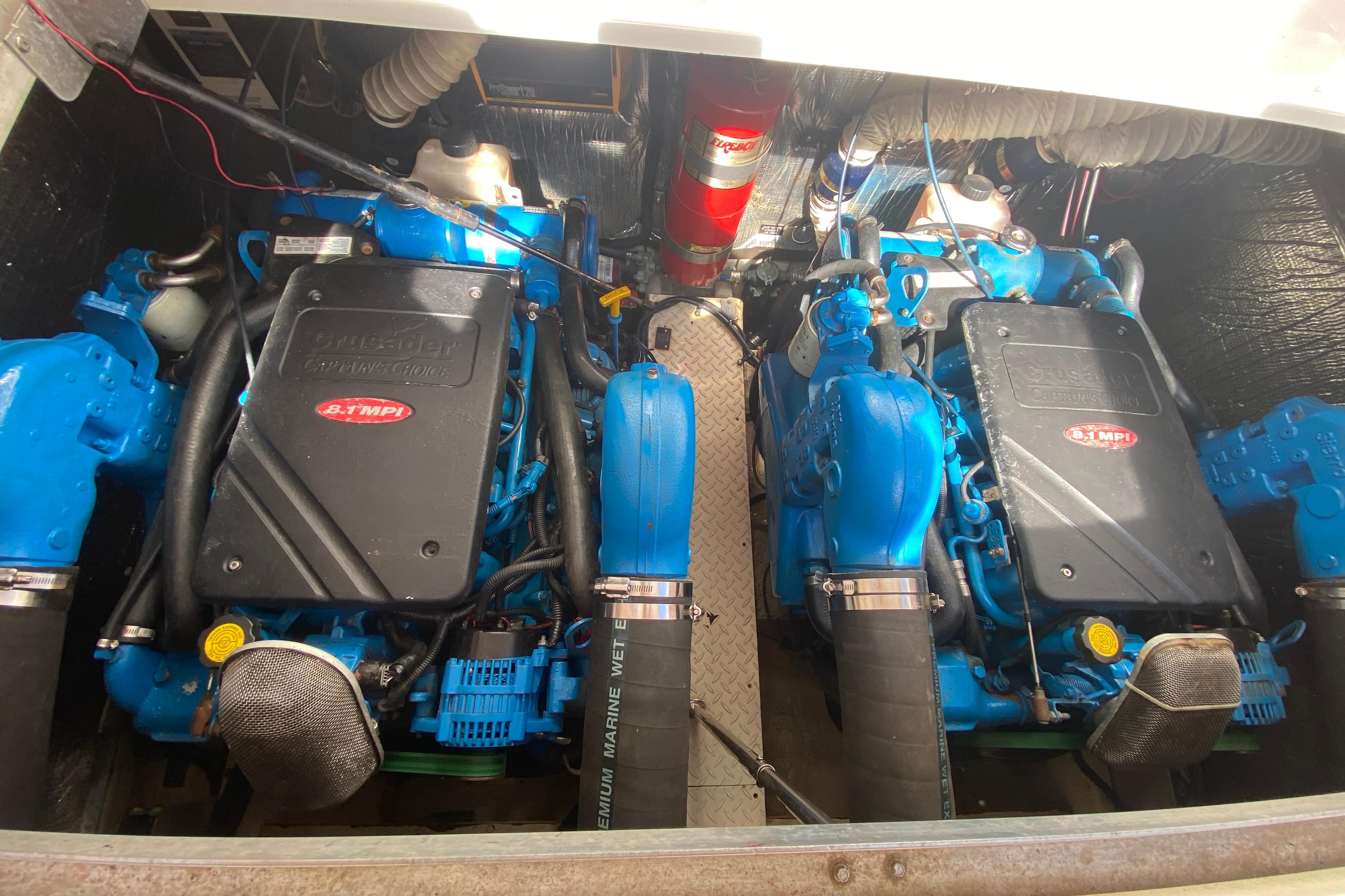Engine compartment of a 2002 Cruisers Yachts 3572 Express, featuring twin blue marine engines.