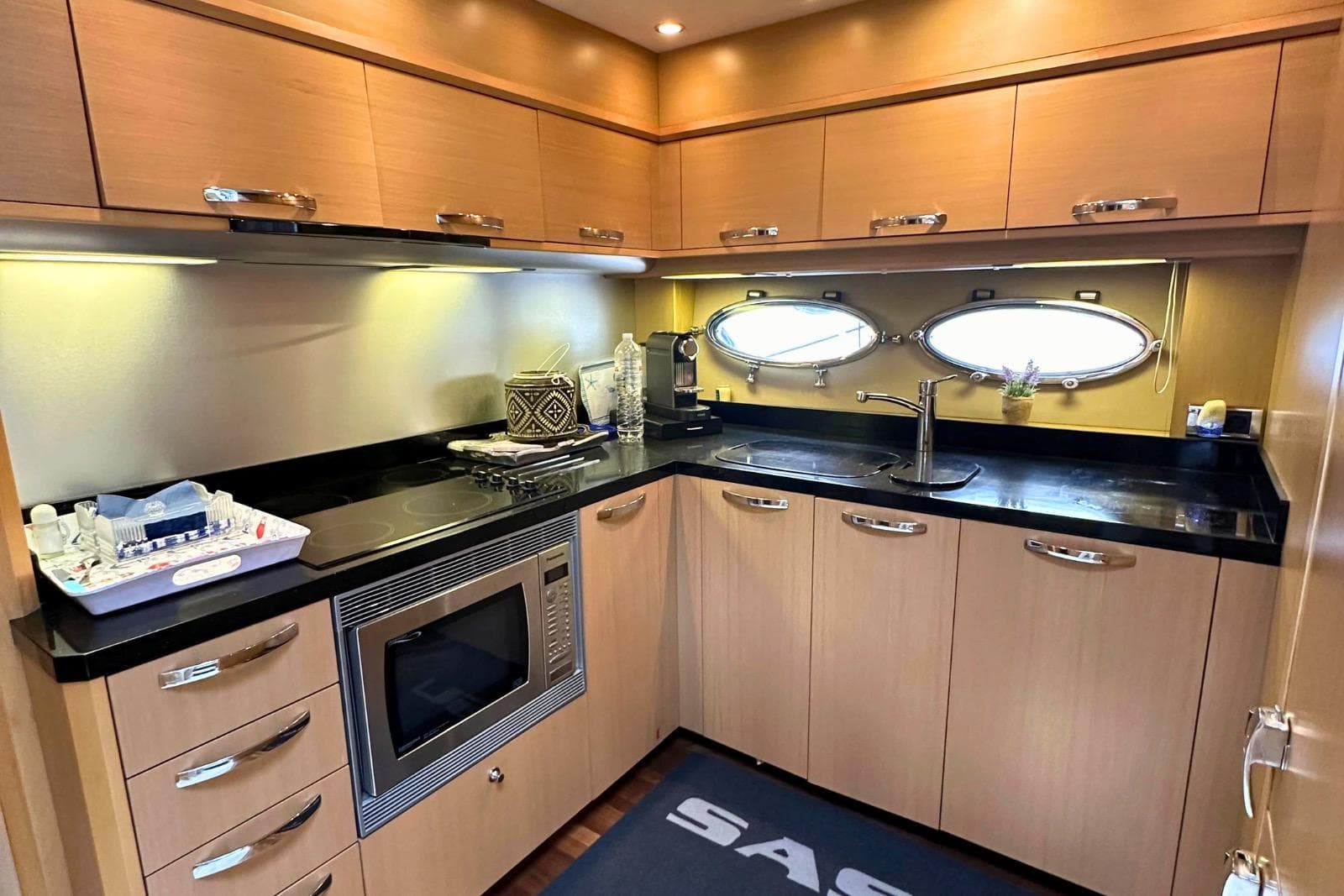 Luxurious kitchen interior of 2009 Princess V65 yacht with modern appliances and sleek design.