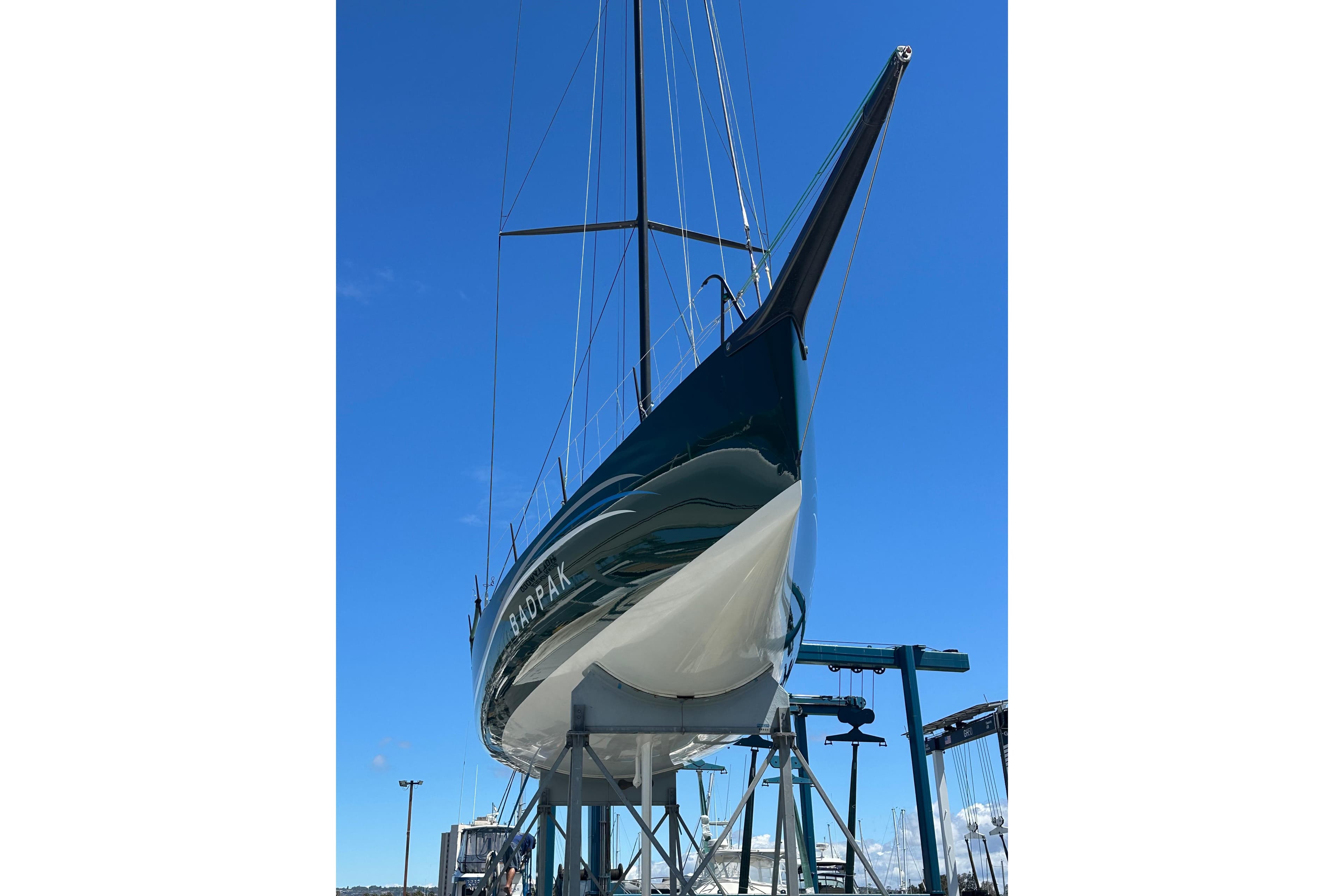 Sleek Botin 56 yacht from 2018 on a lift against a clear blue sky.