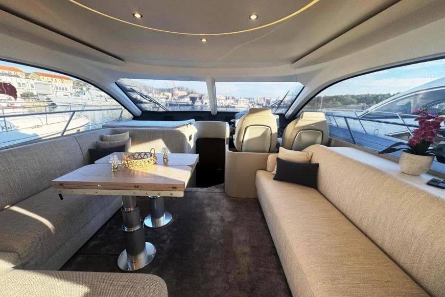 Luxurious interior of 2024 Azimut Fly 53 yacht with elegant seating and panoramic windows.