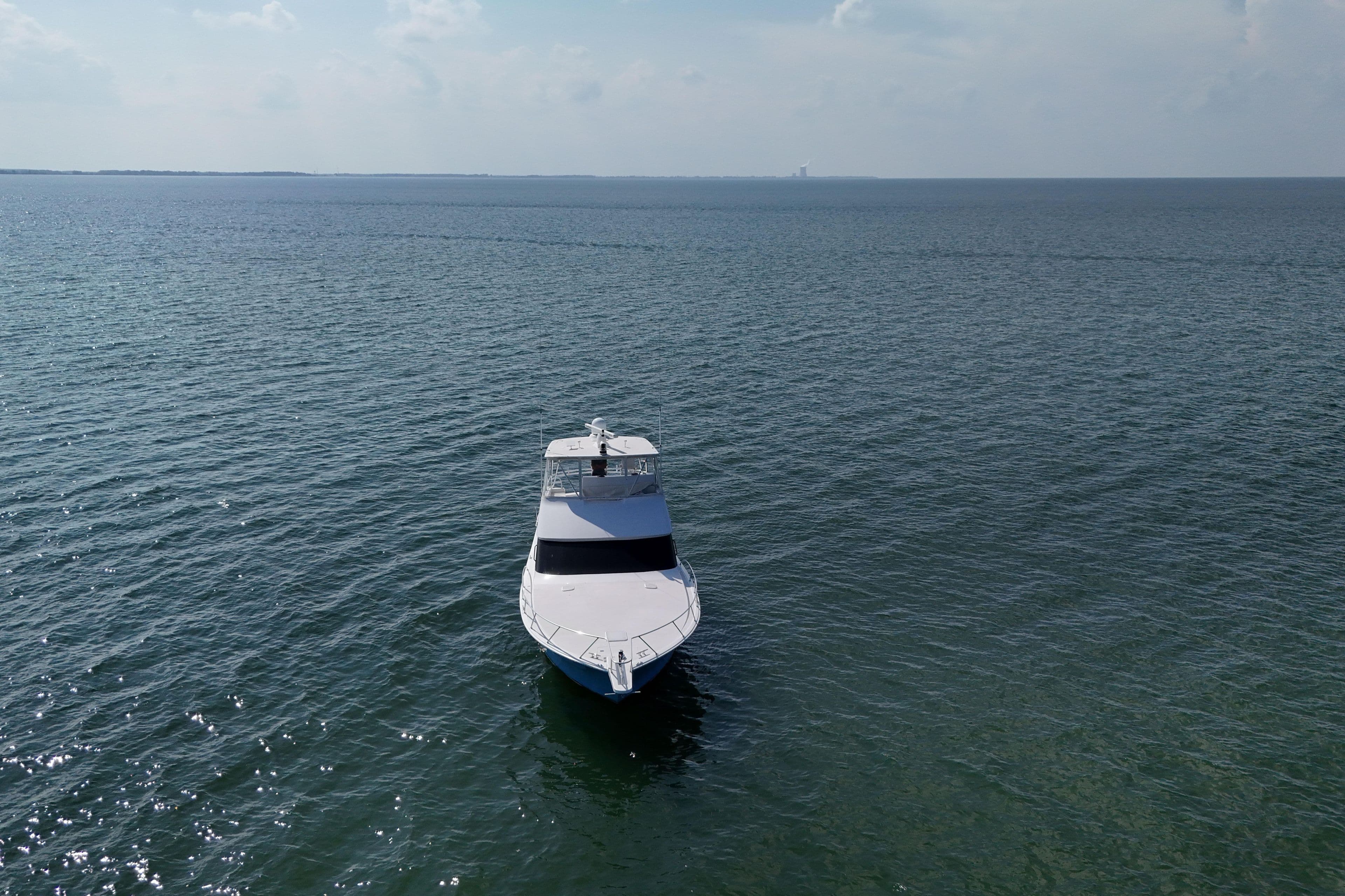 2003 Viking 48 Convertible yacht on open sea under clear sky.