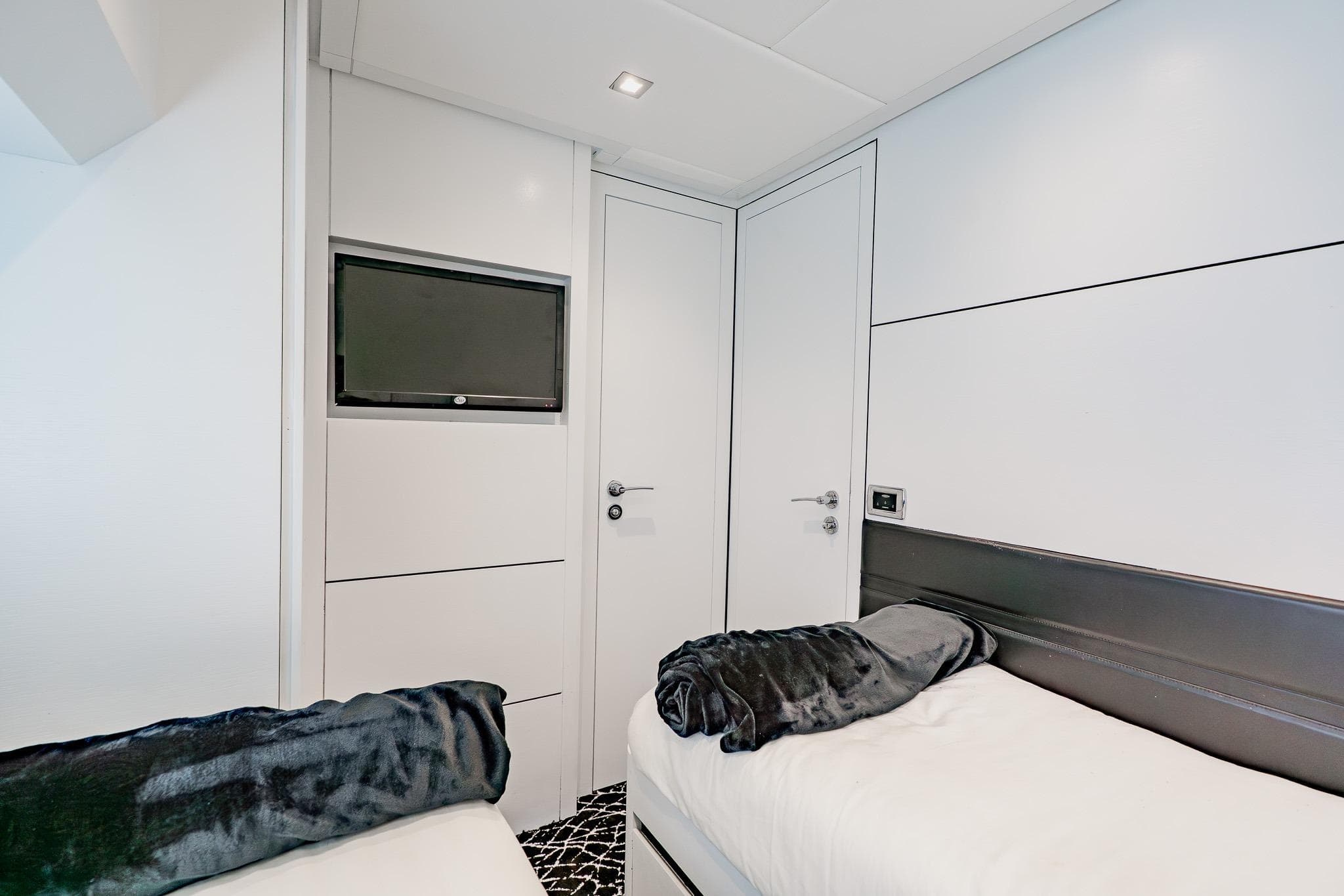 Luxurious interior cabin of 2010 Pershing 80 yacht with modern design and twin beds.
