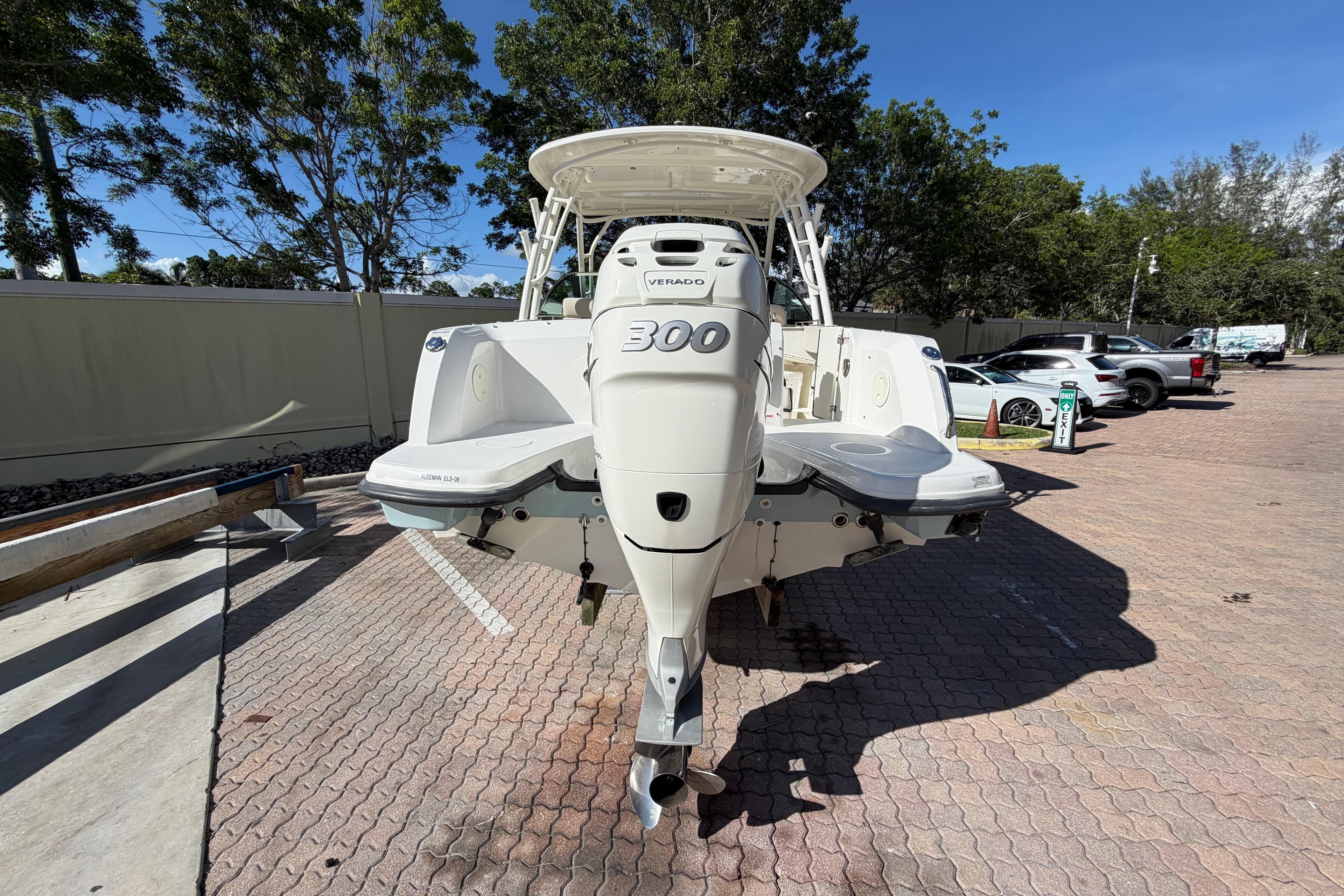 2016 Boston Whaler 230 Vantage boat with powerful 300 Verado engine, parked outdoors.