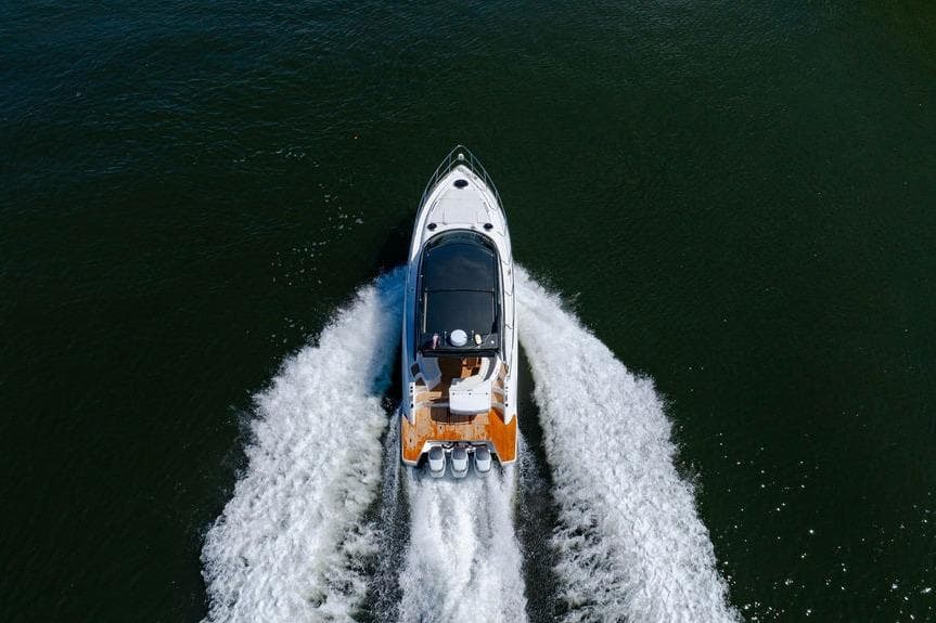 Aerial view of 2022 Schaefer 400 Sport boat cruising on water.