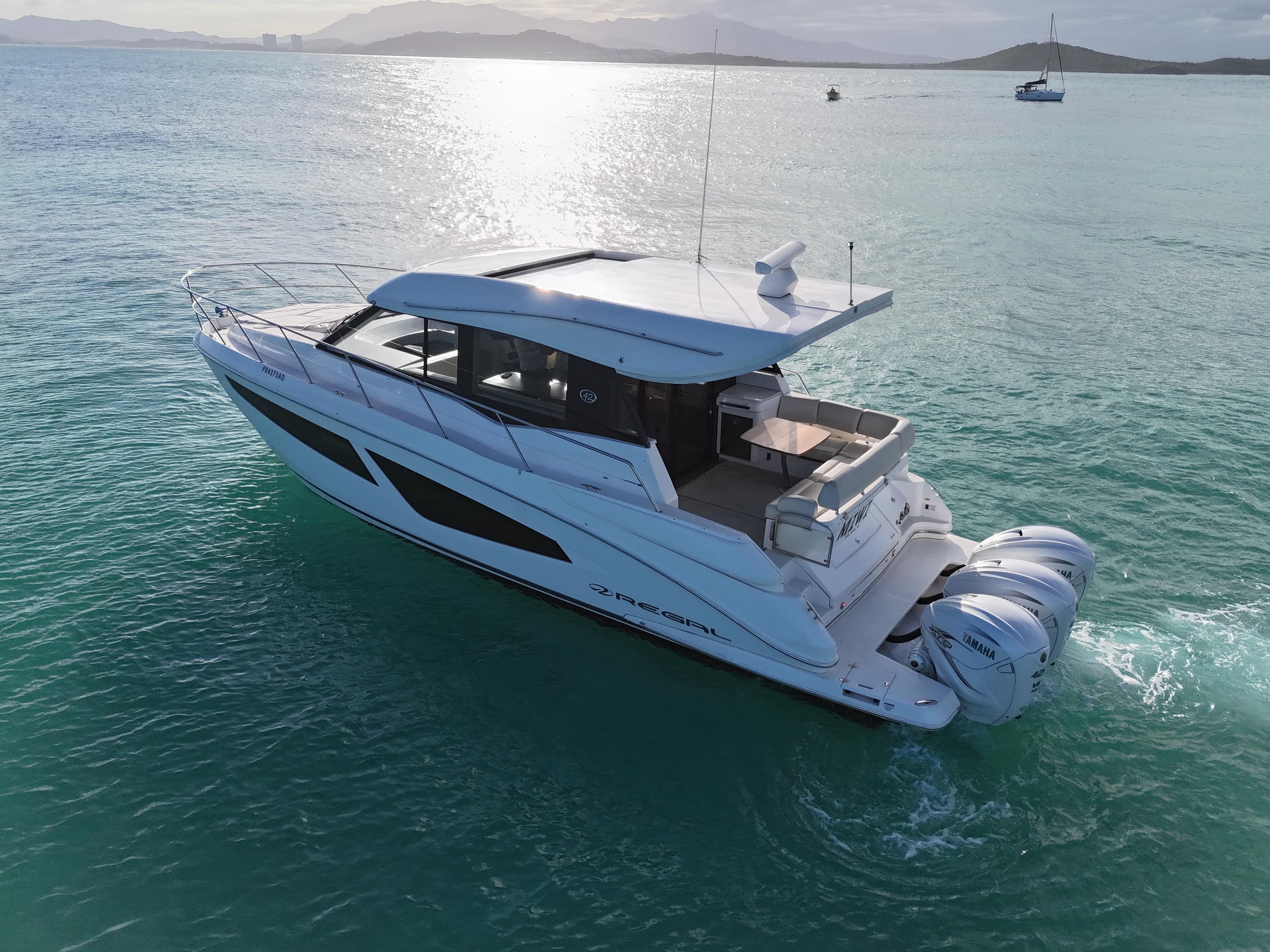 2022 Regal 42 XO yacht cruising on serene turquoise waters.