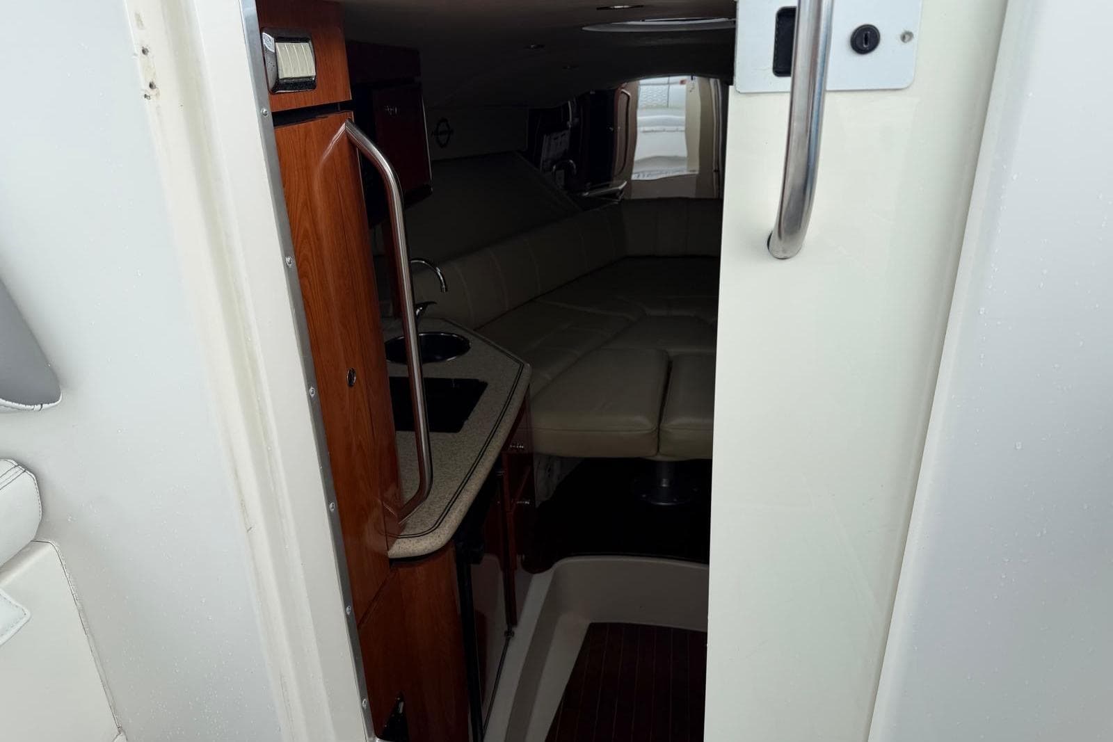 Interior view of 2007 Fountain 38 Tournament Edition boat cabin with kitchenette and seating area.