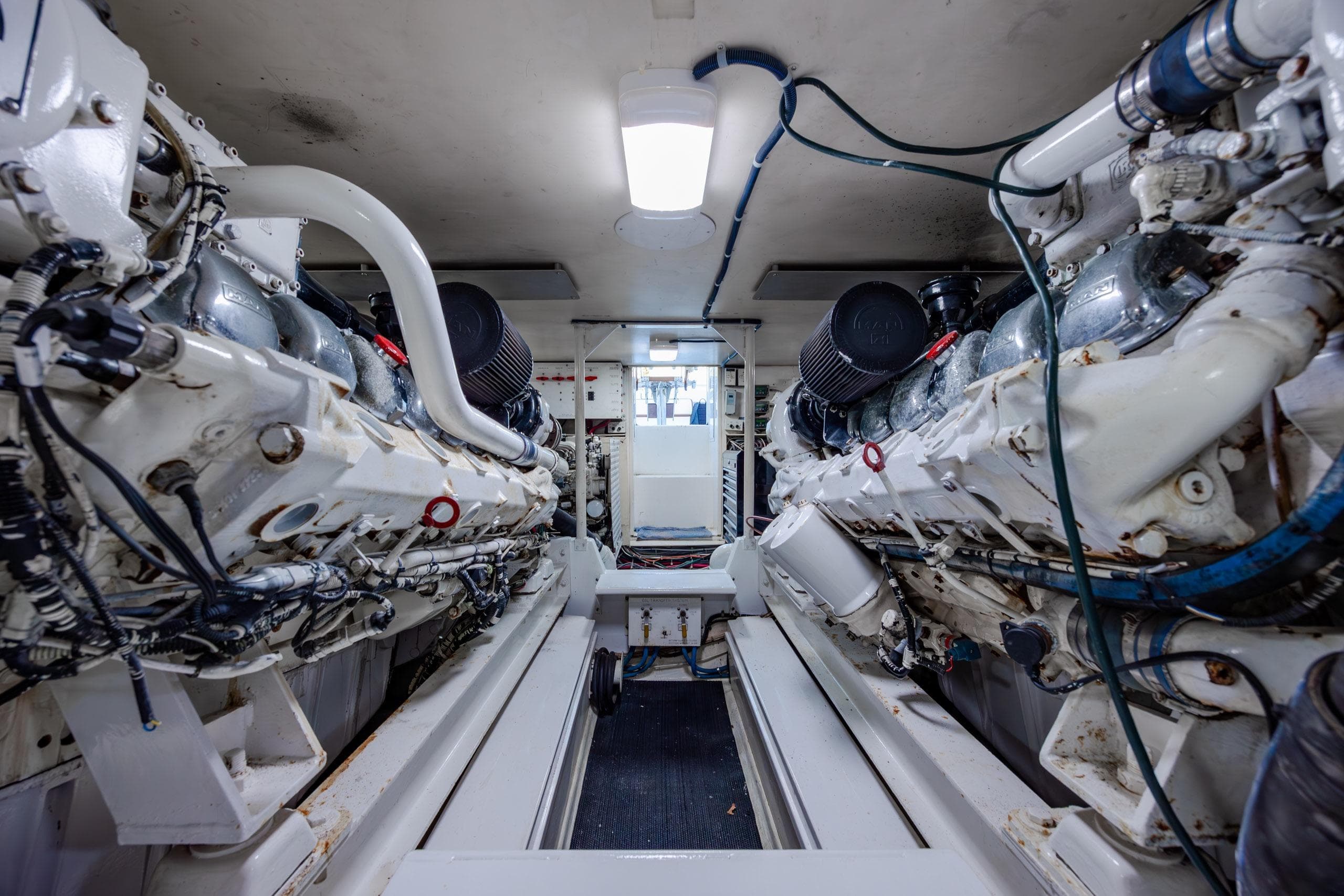 Engine room of a 2000 Viking 55 Convertible yacht, showcasing dual powerful engines.